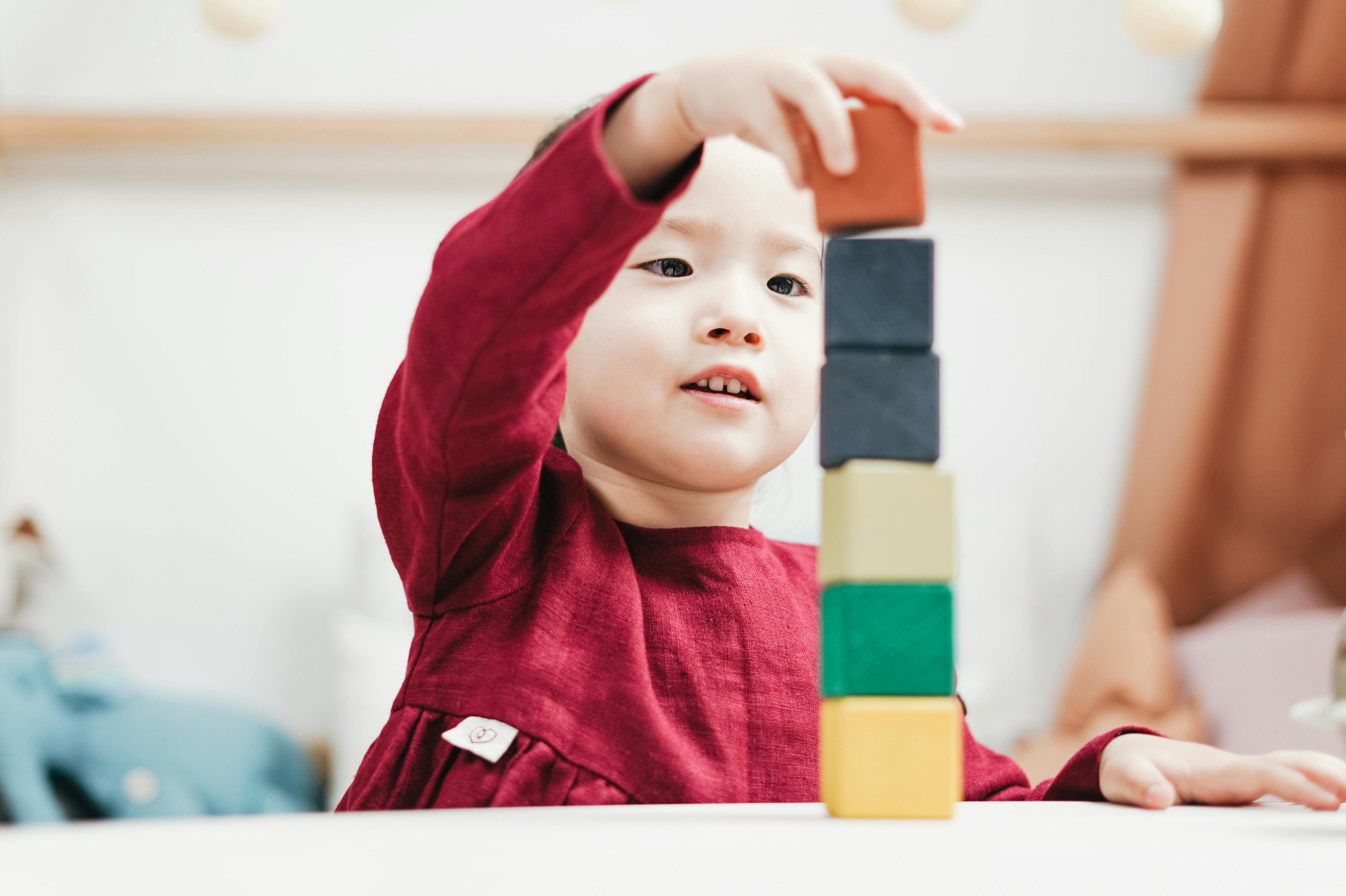 child stacking blocks