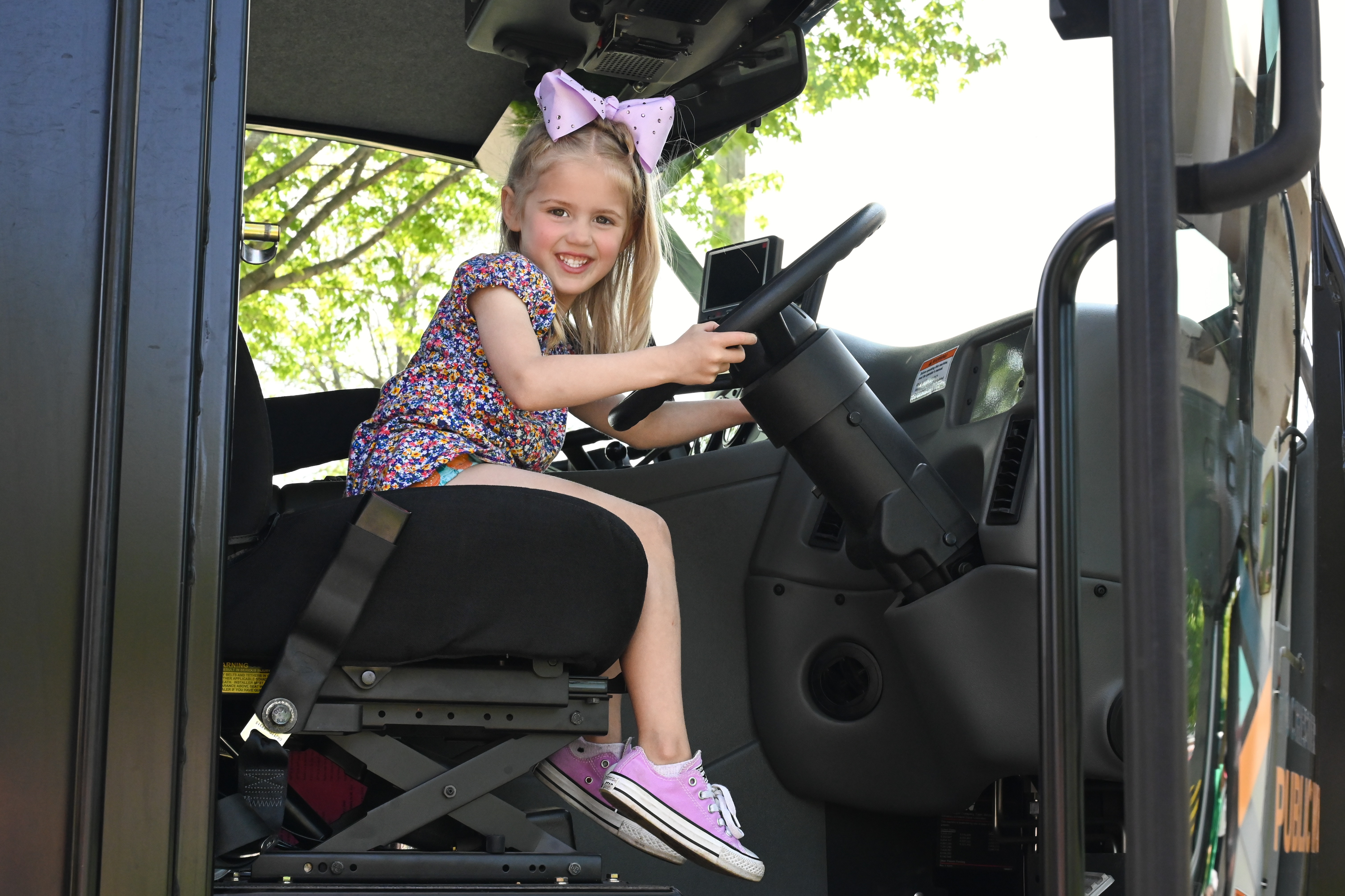 young girl sitting in large truck