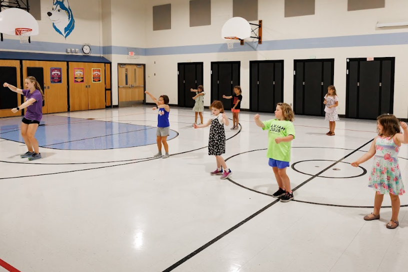 dance instructor teaching a group of young girls