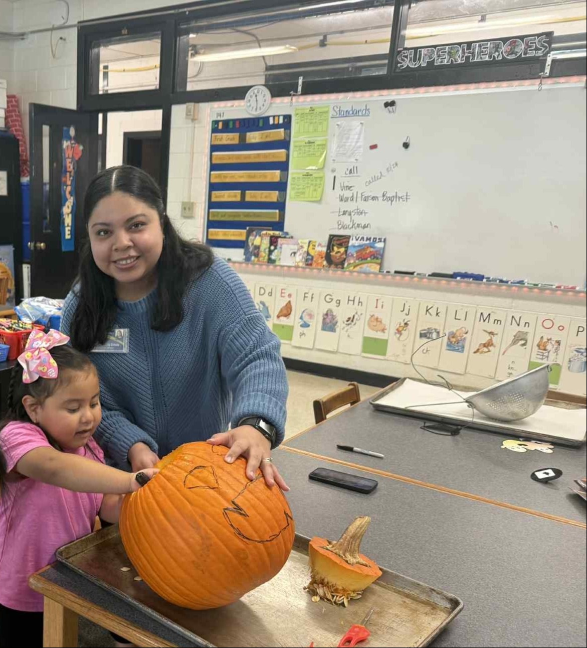 Migrant Ed. helping in a pumpkin lesson