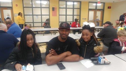 dad with daughters at school