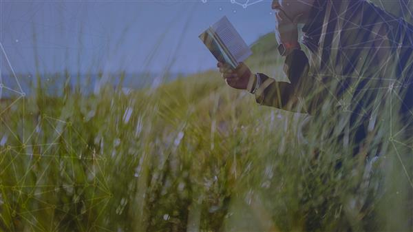 Student reading in wheat field