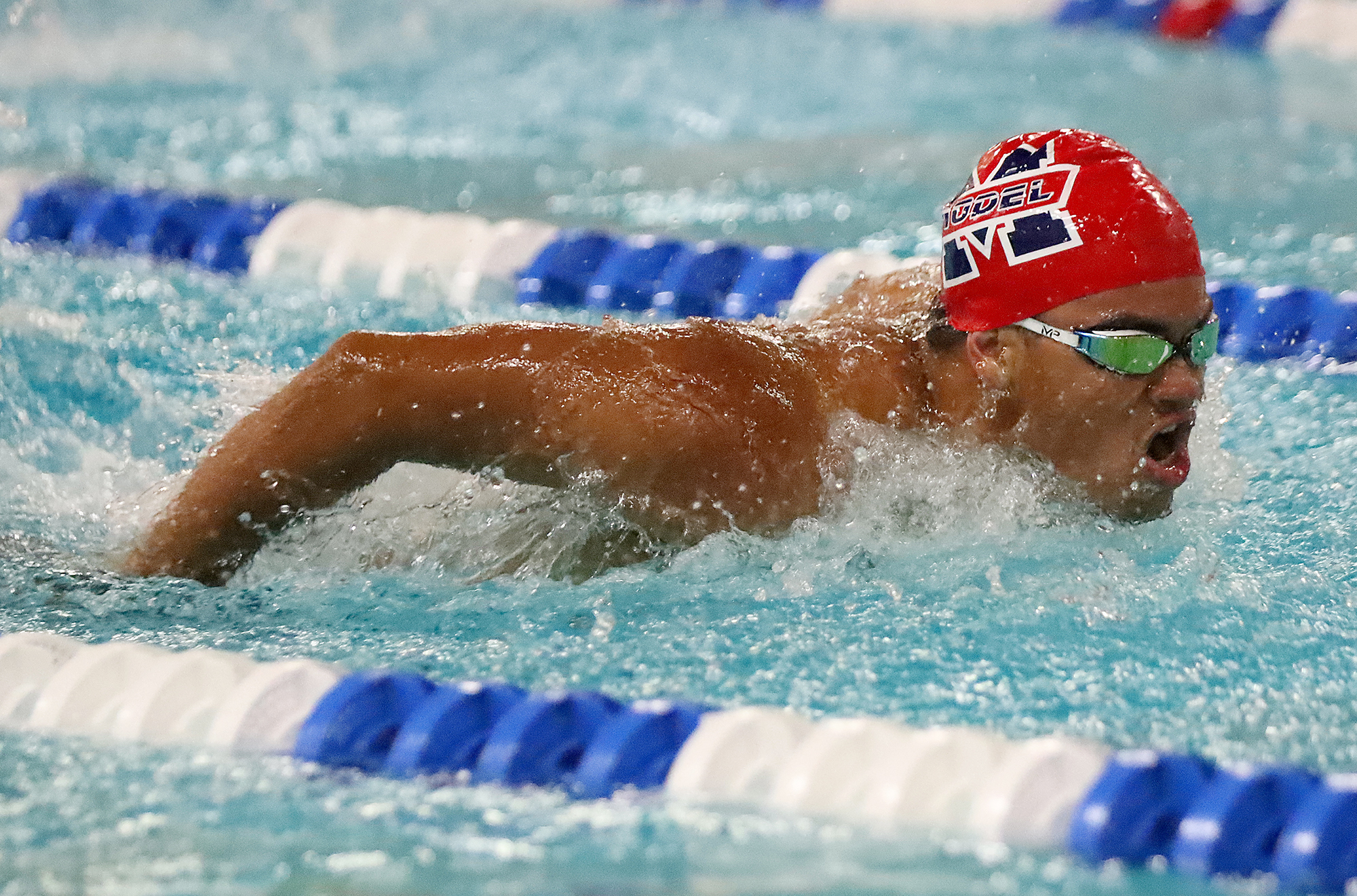 Student swimming at a meet