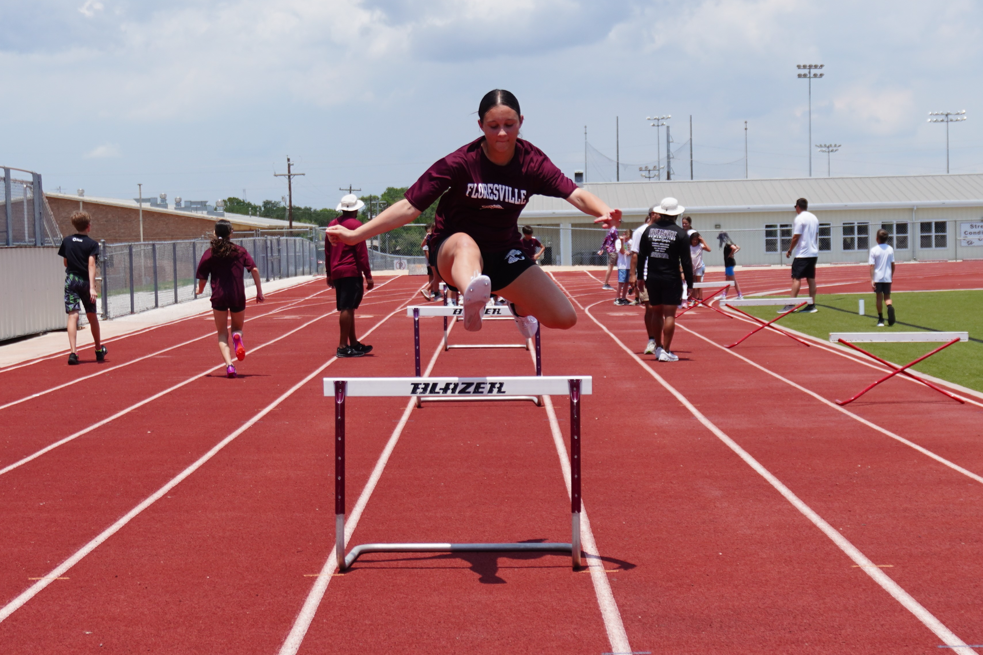 girl jumping hurdles