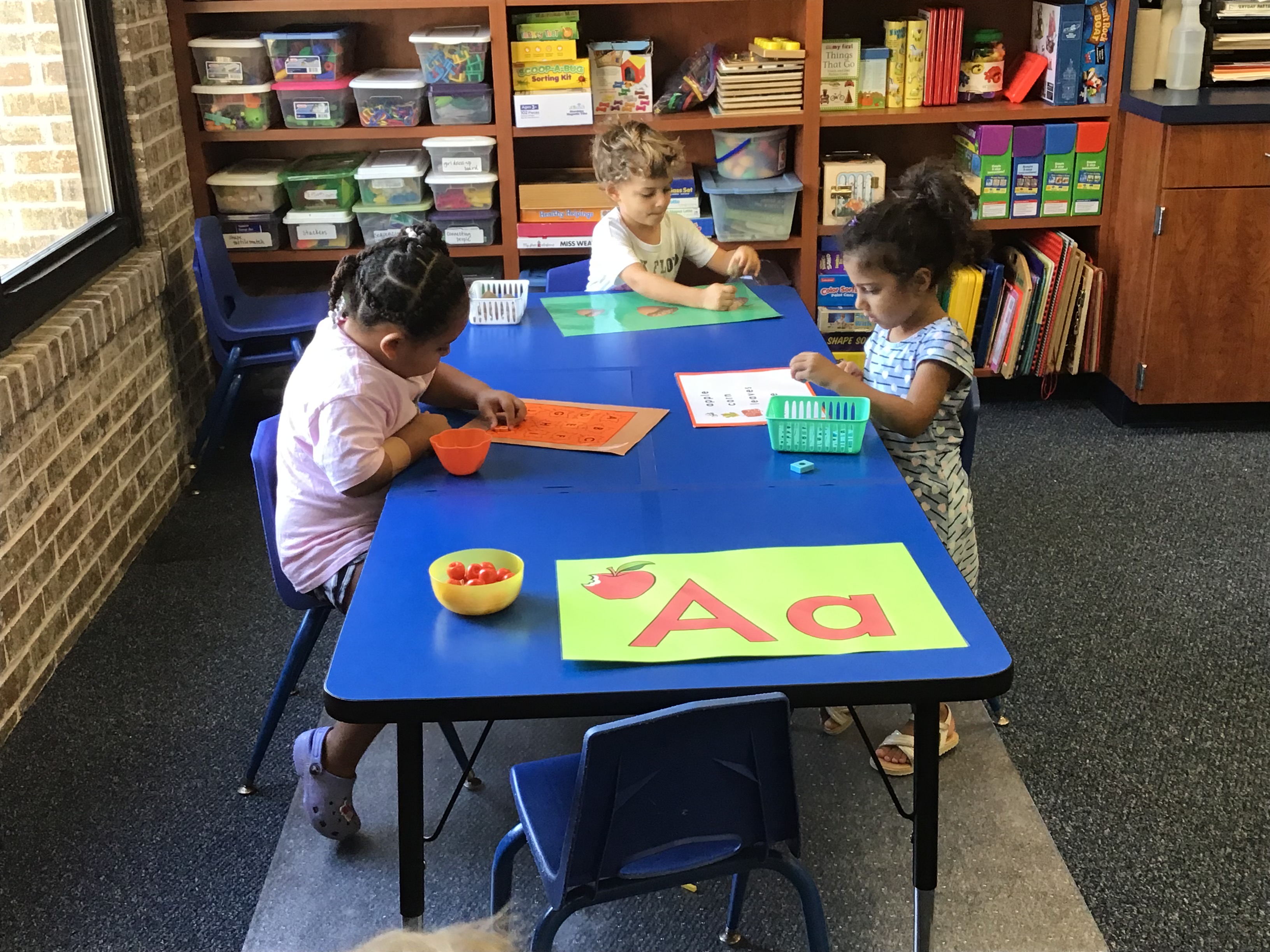 Friends playing at literacy table