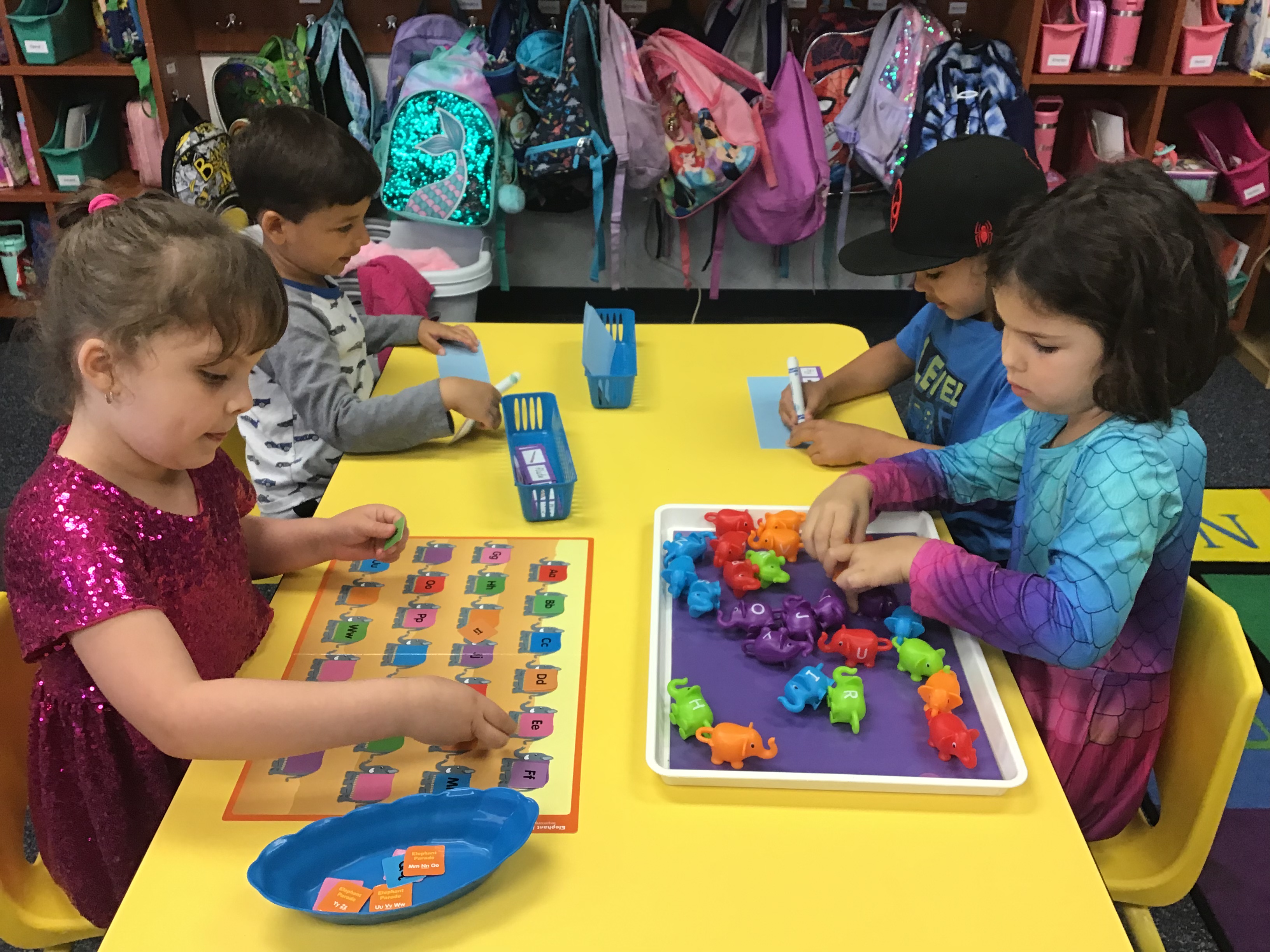 Students at the phonics table completing a missing letter Elephant activity.