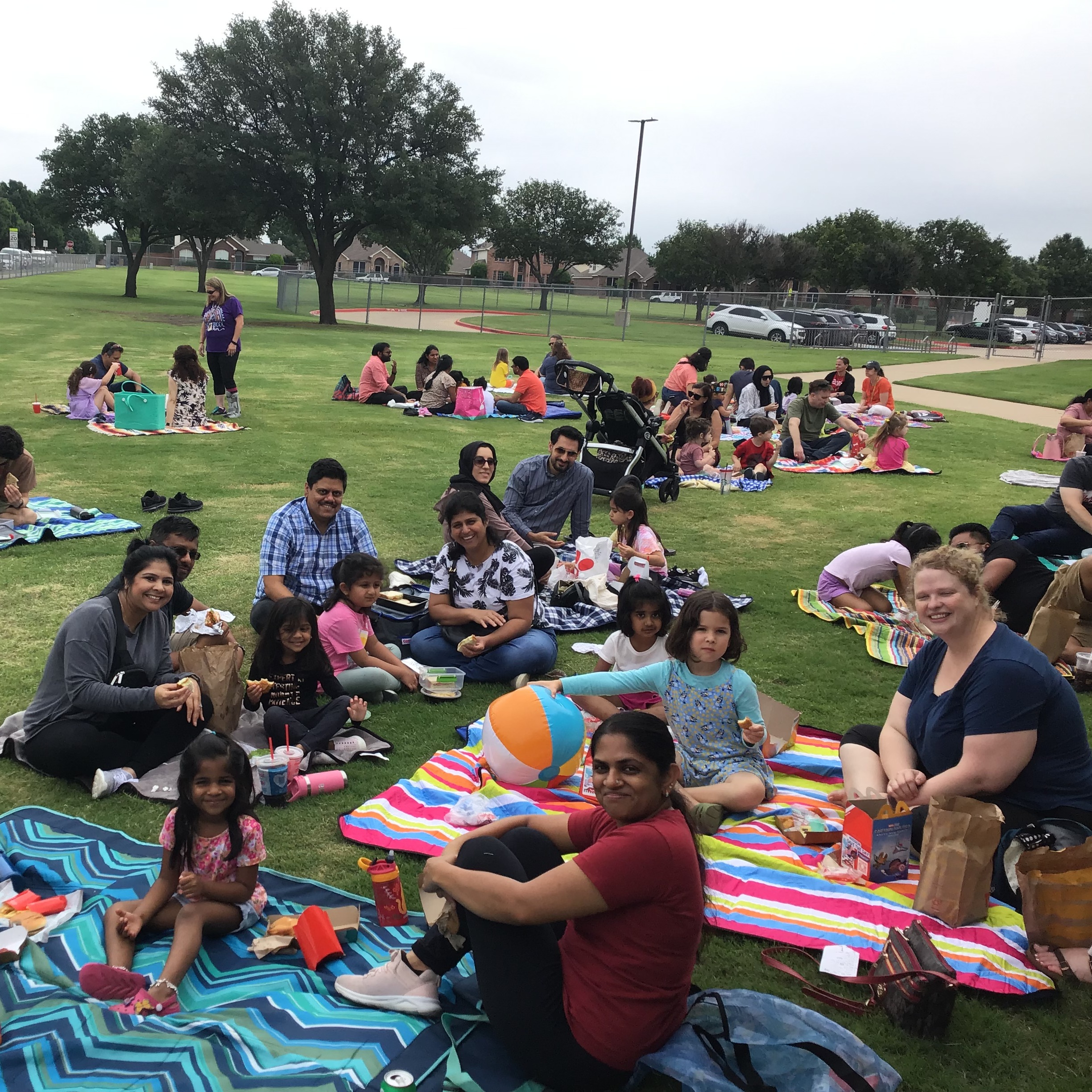 Group picture of families enjoying lunch at the family picnic