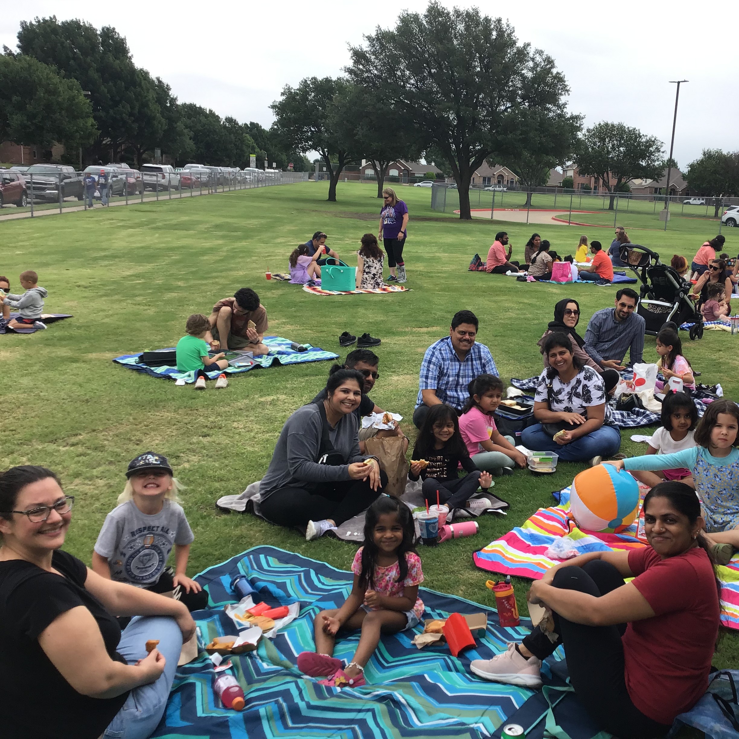 Group photo of families having lunch at the picnic