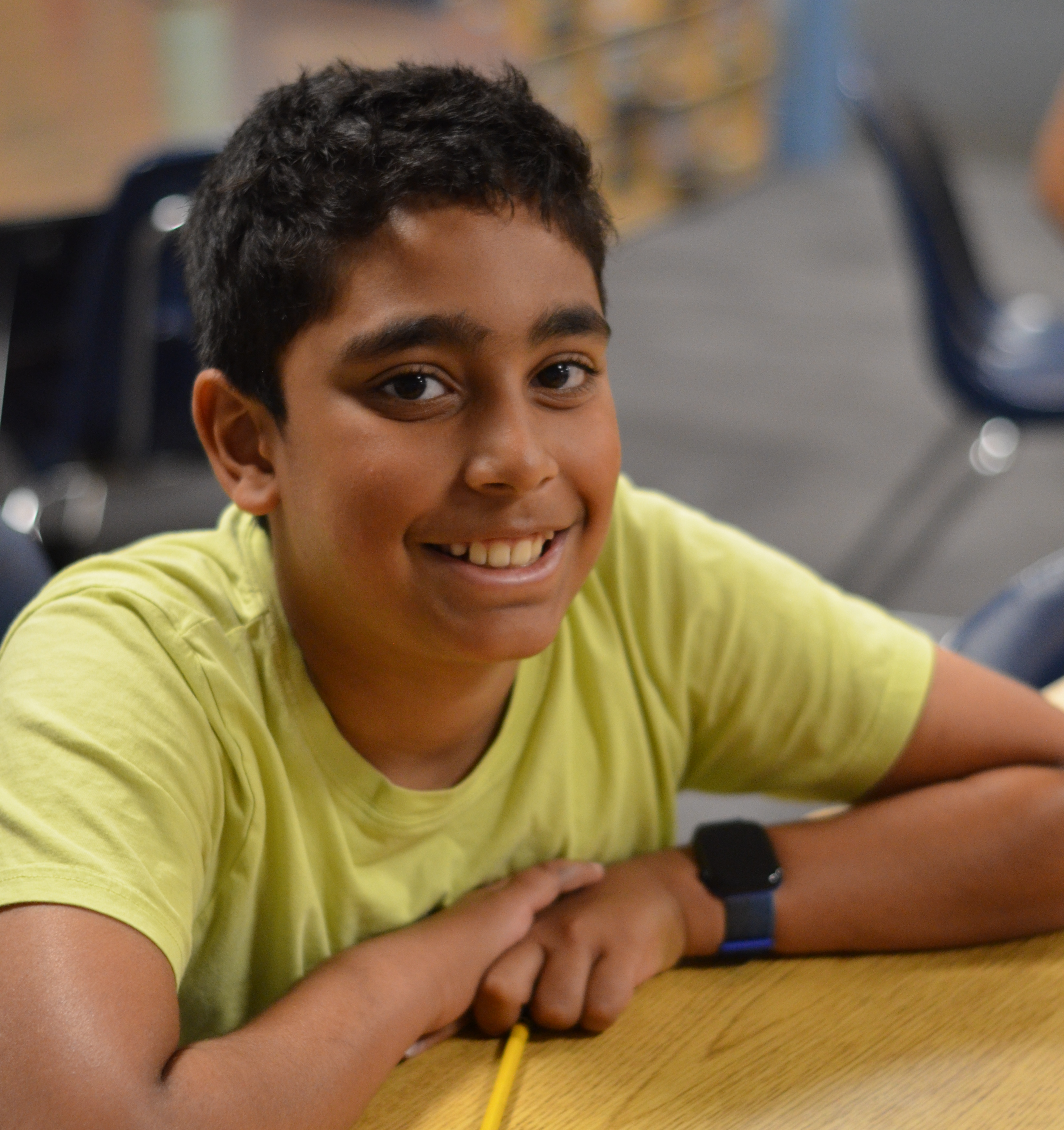 Fifth grade student smiling at the camera in class