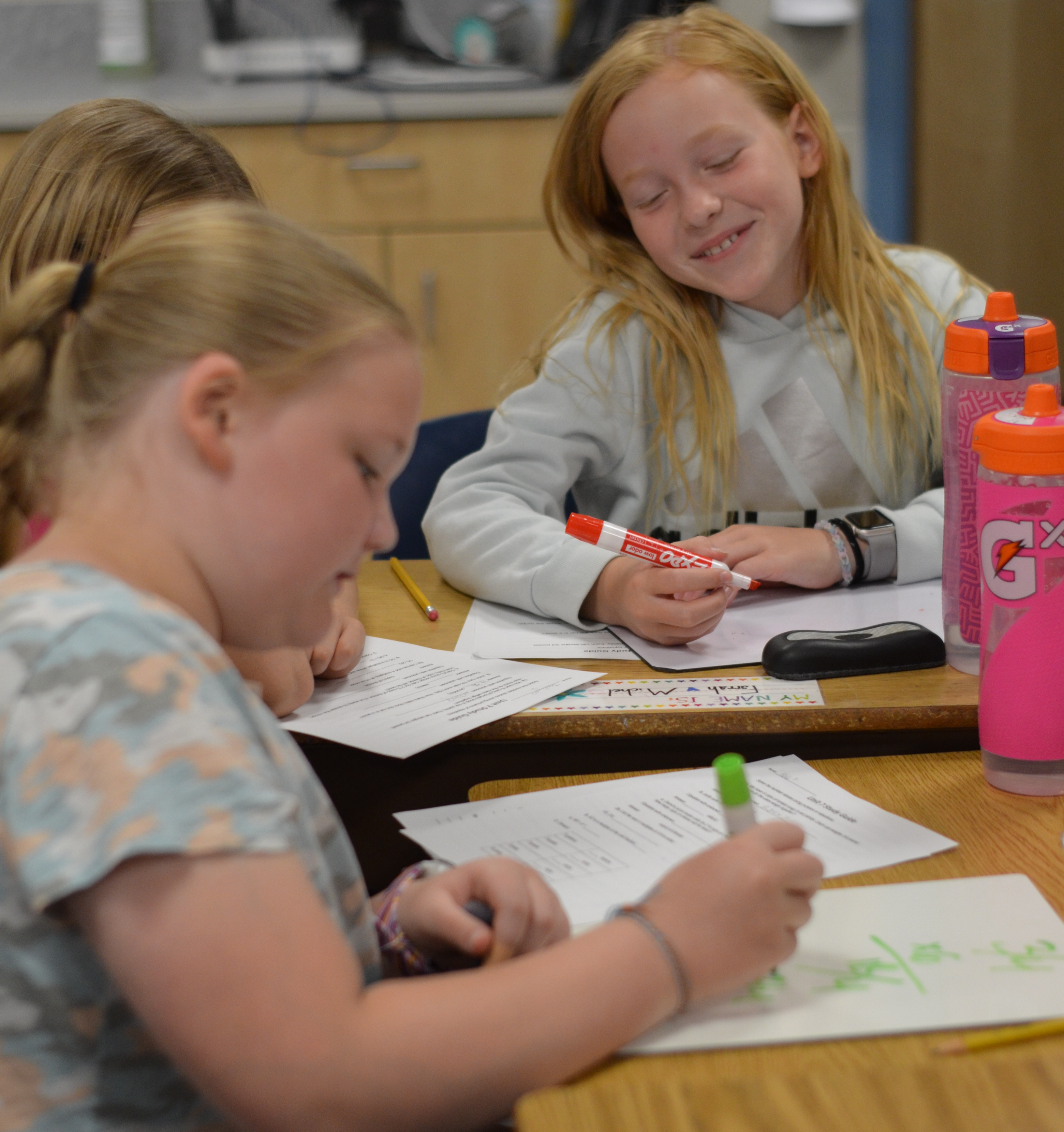 Image of three fourth grade female students working together on classwork.
