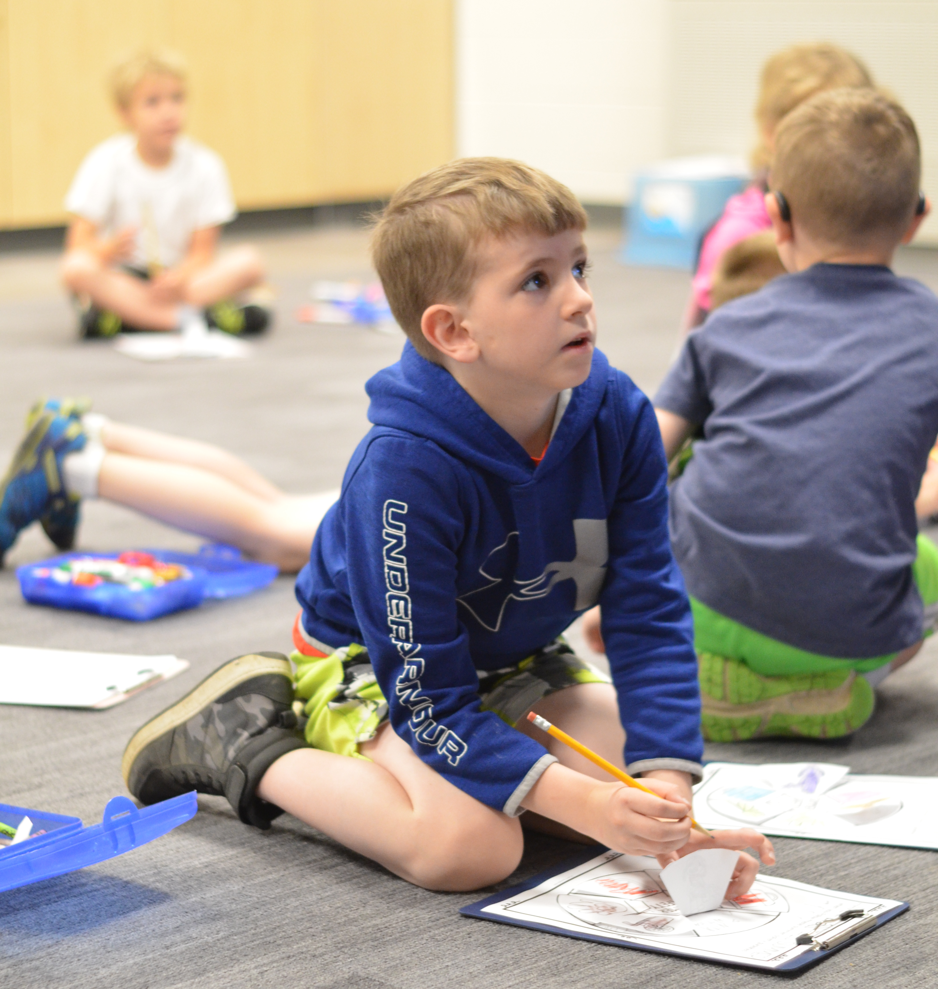 Image of male second grade student working on an independent project coloring