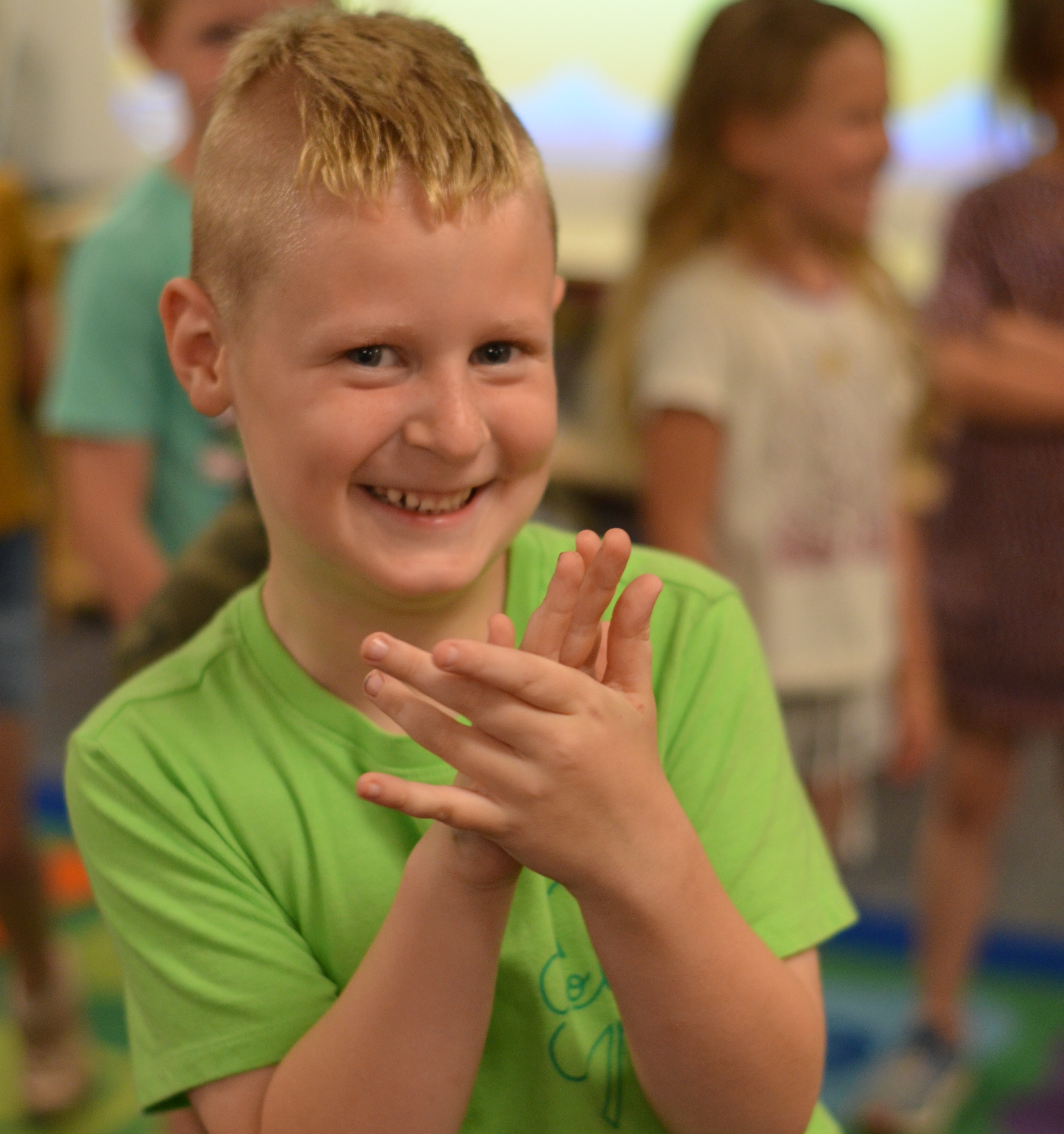 Image of a male fourth grade student doing a dance exercise in class