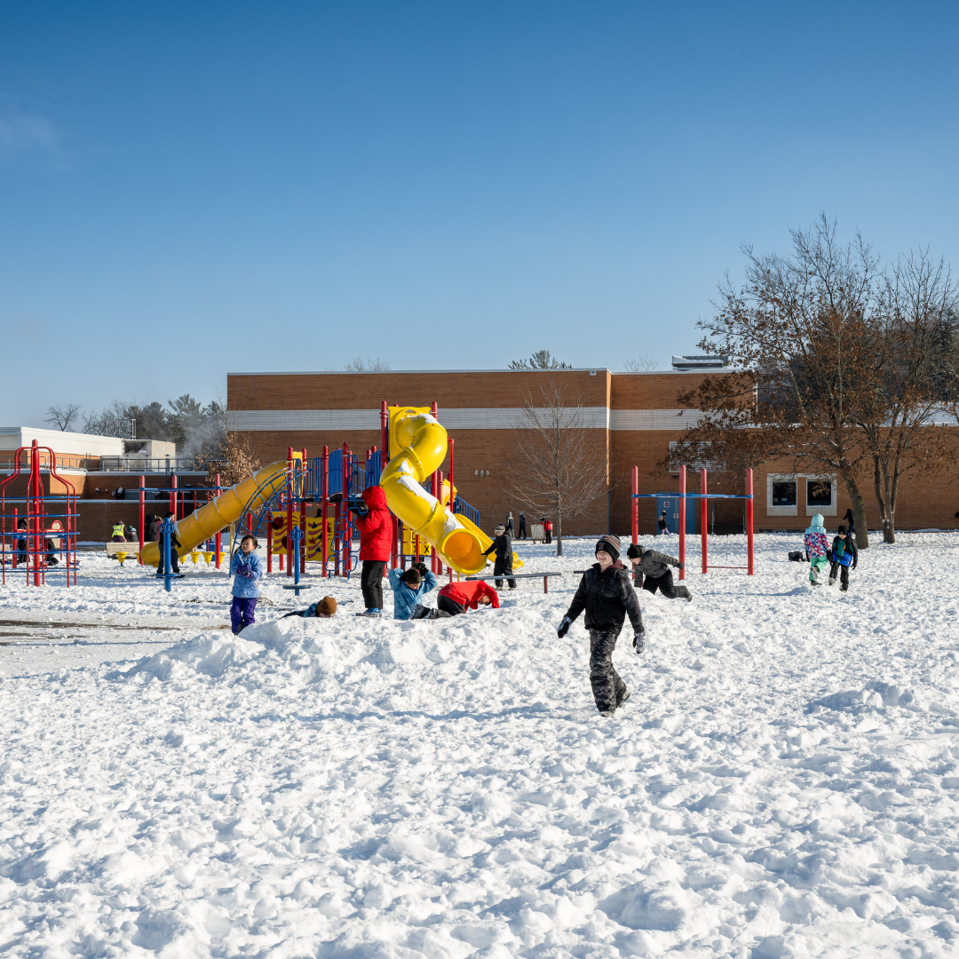 students outside on the playground in the middle of winter