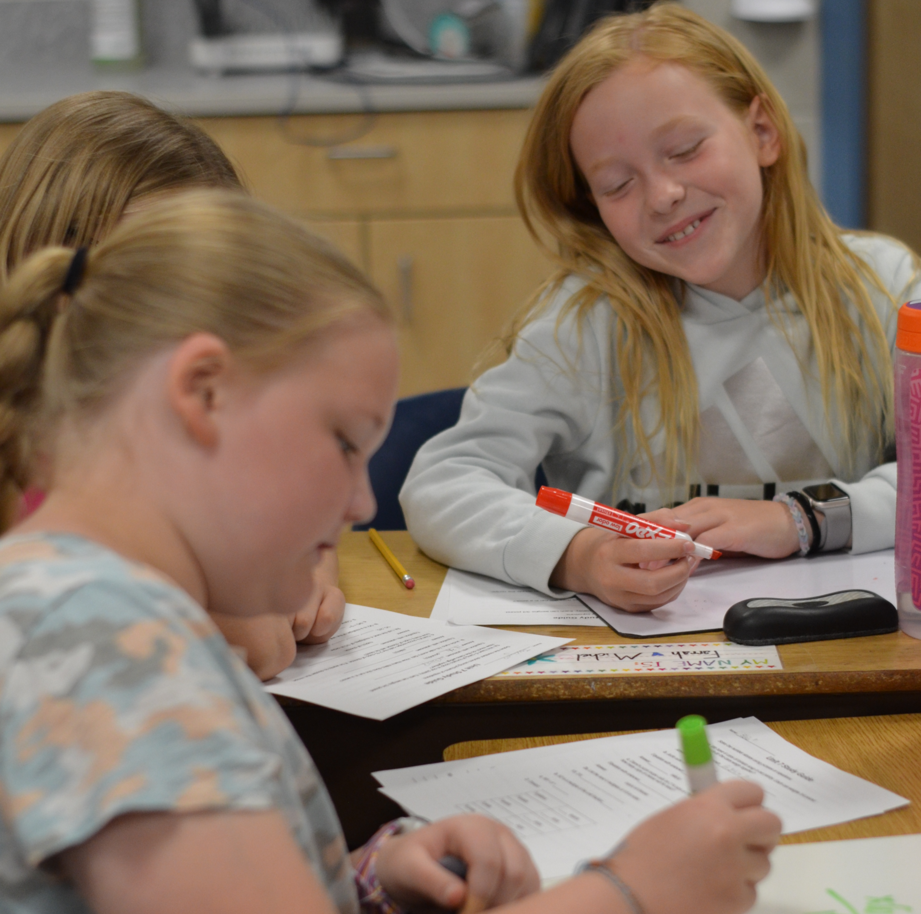 Image of three fourth grade female students working together on classwork.