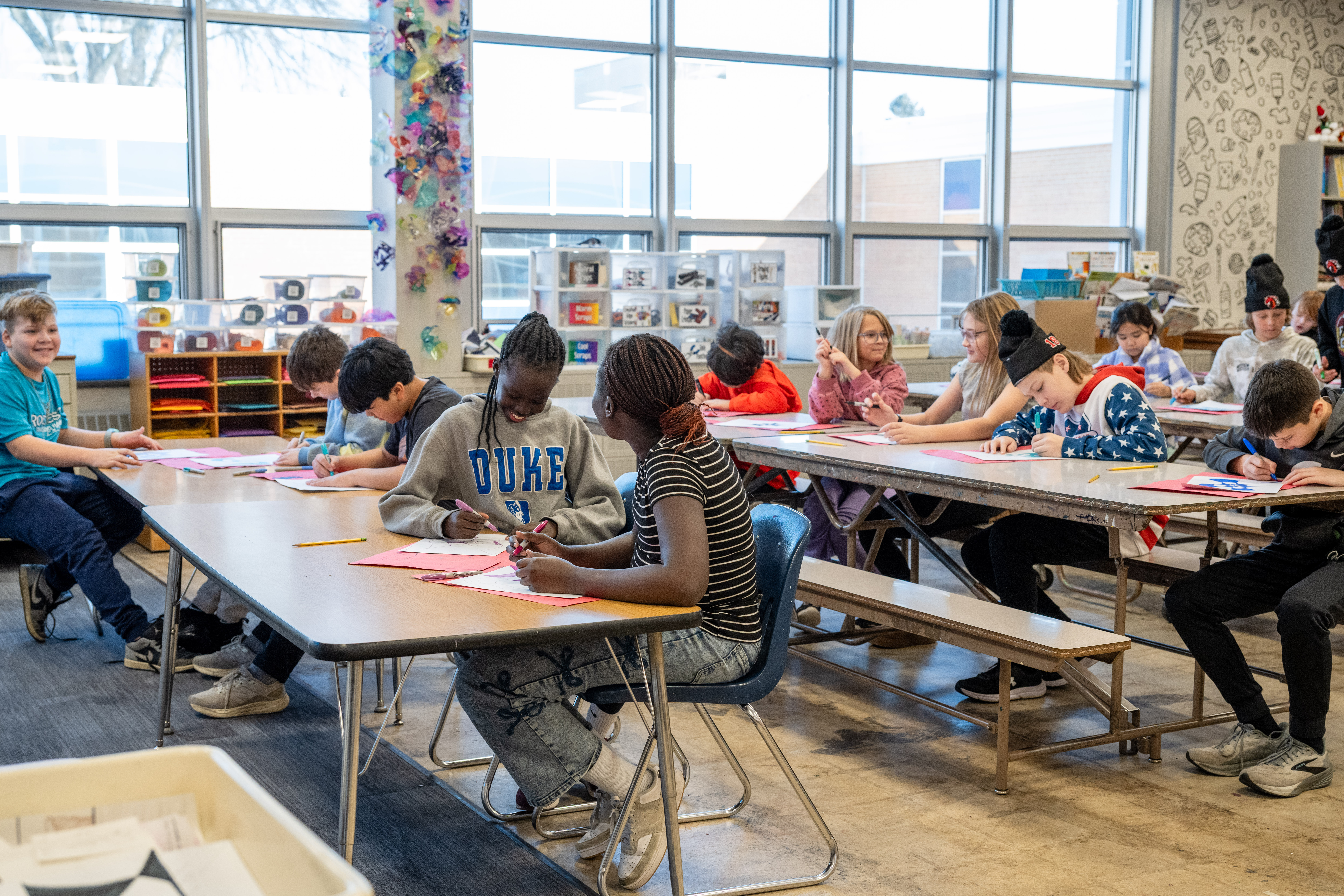 Elementary schoolers work diligently of their art projects.