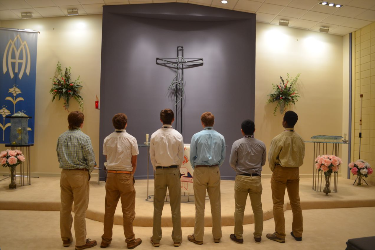 students standing in front of the Cross