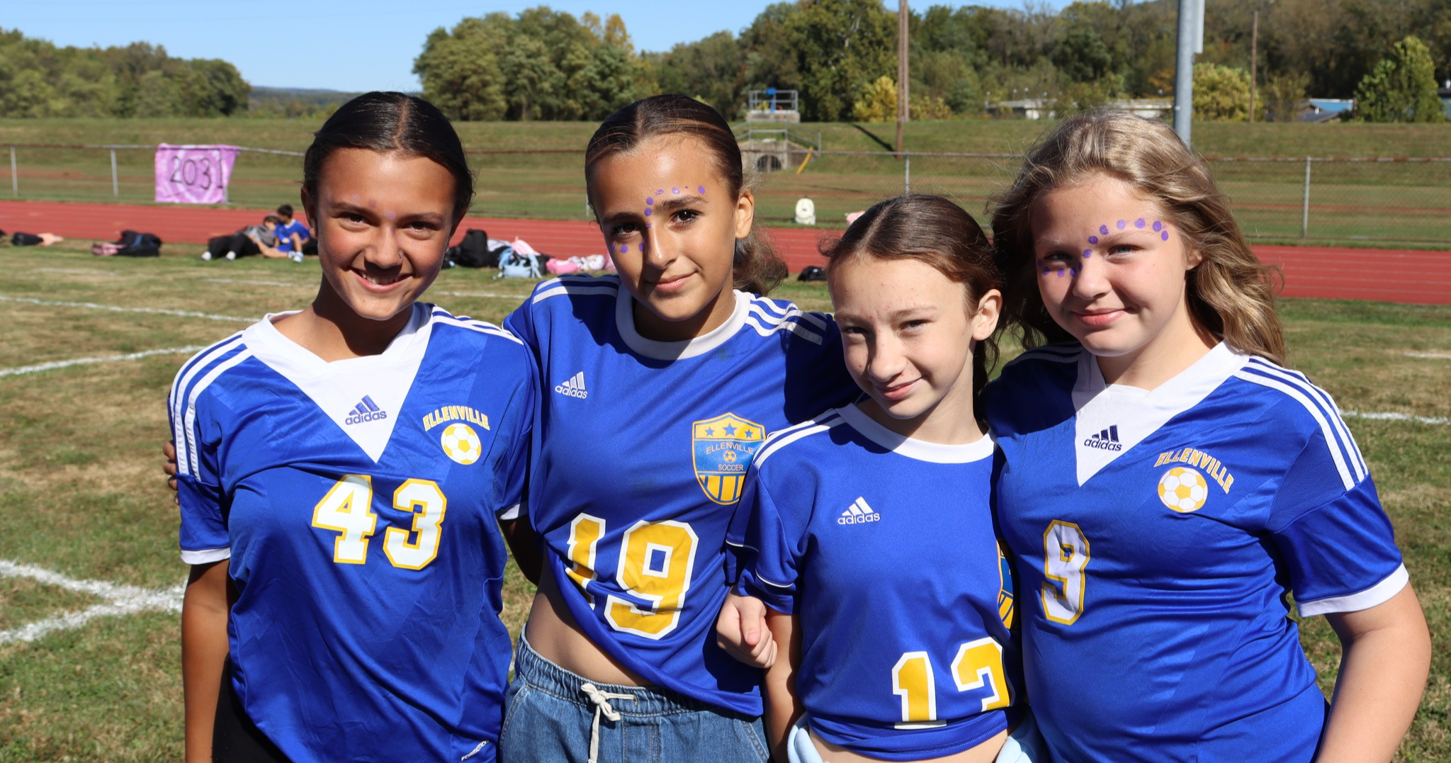 Students wearing team uniforms outside
