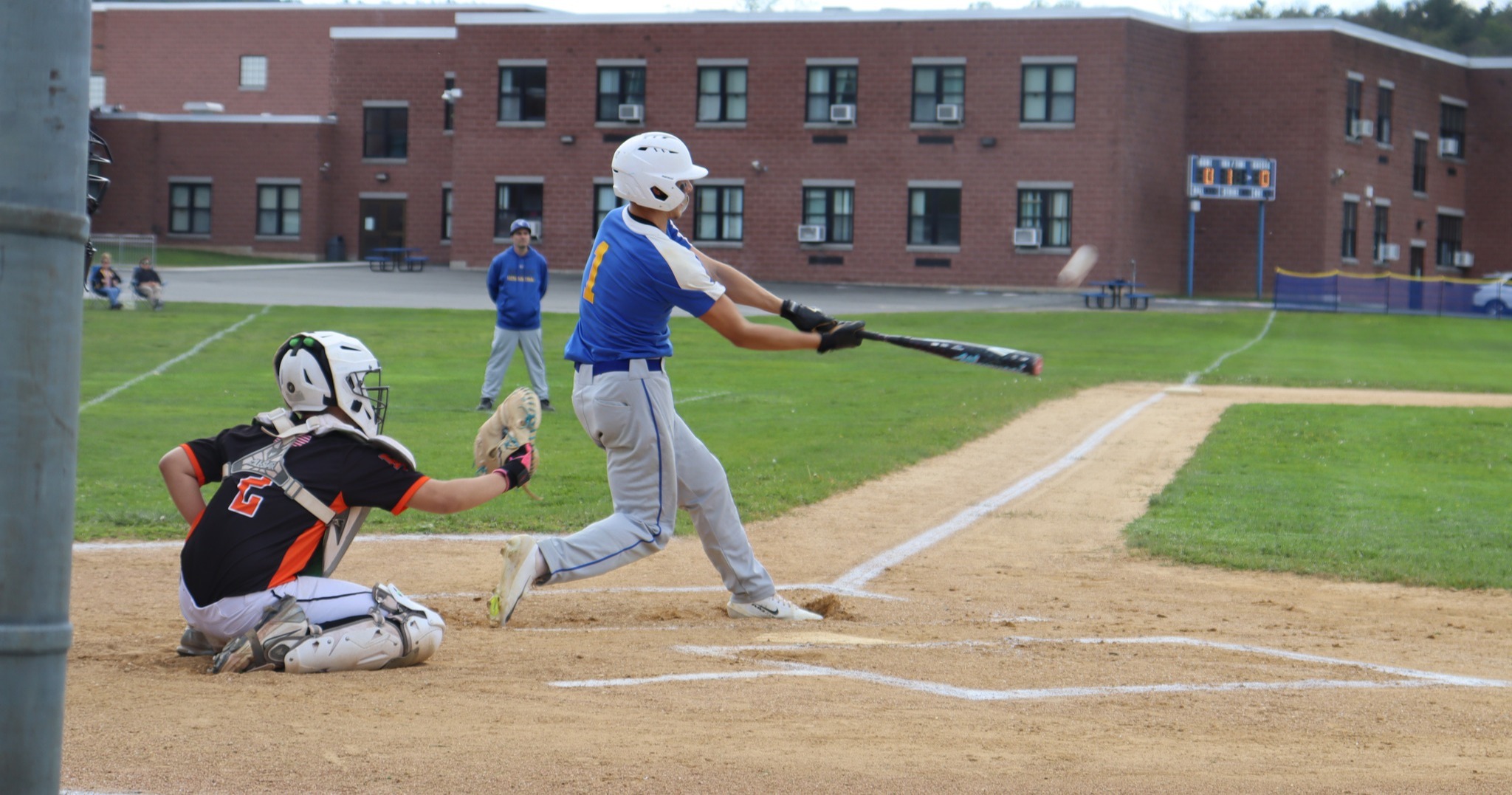 A baseball player swings at the ball