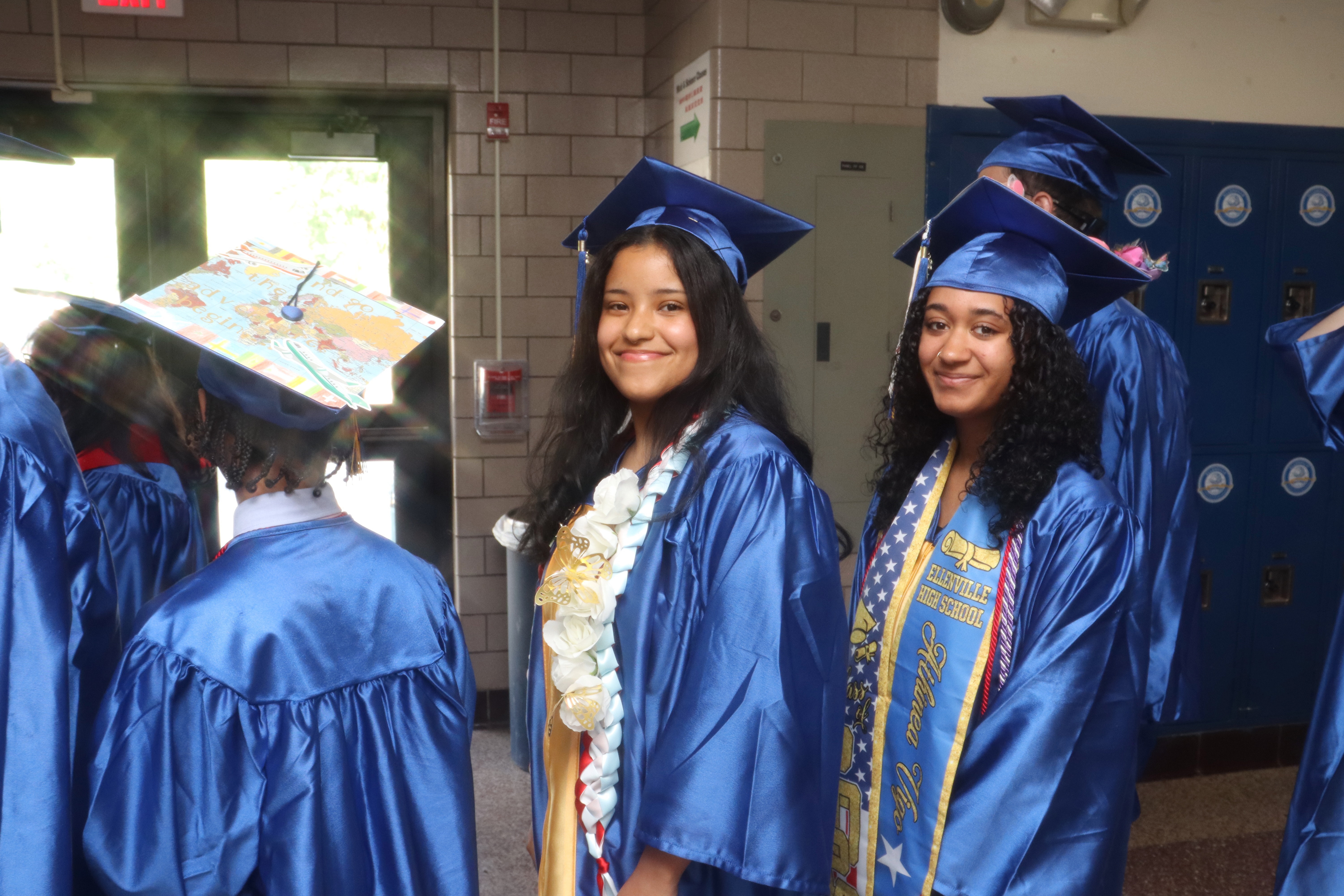 Graduates smiling in a line