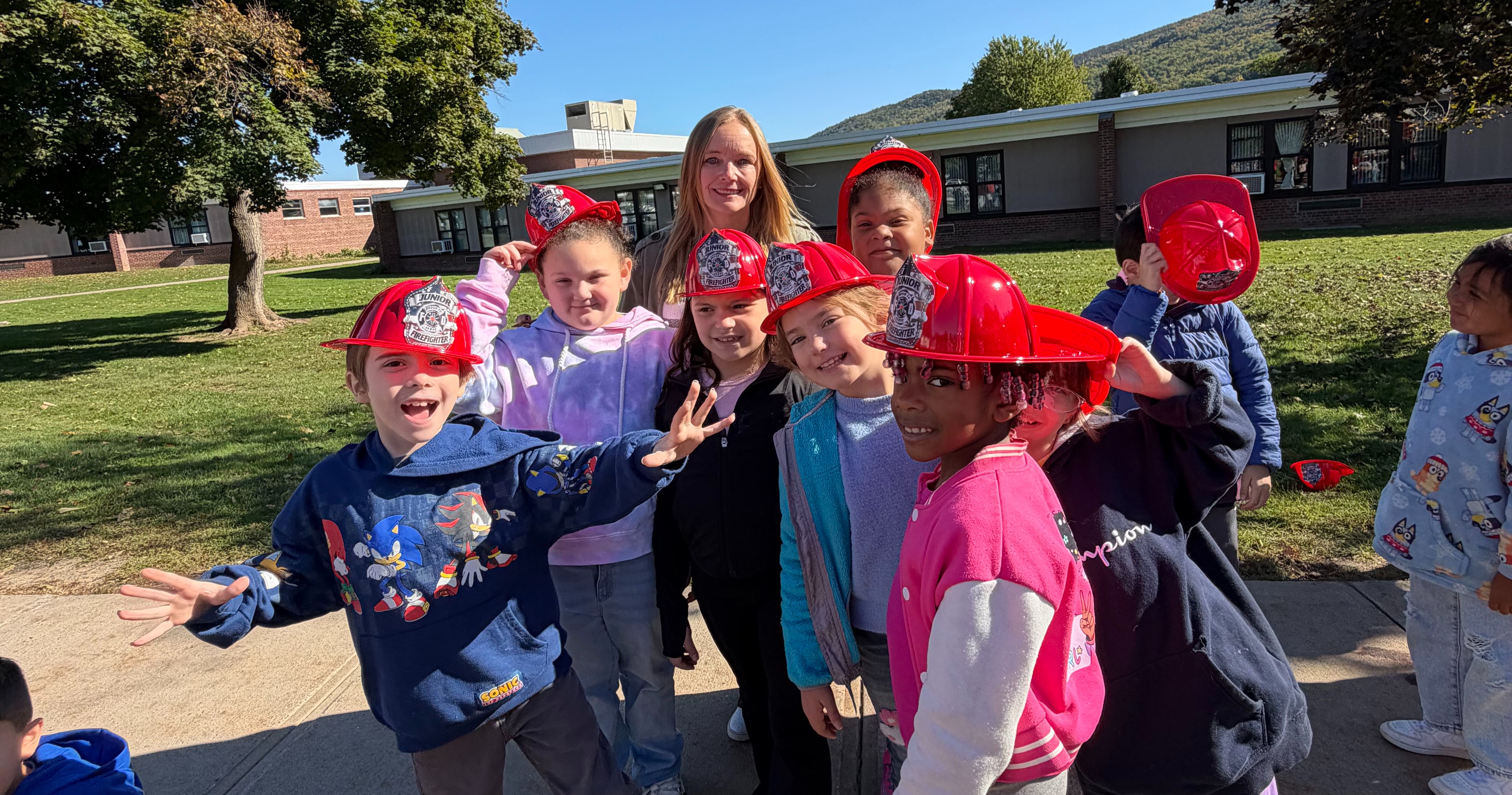 A group of students wearing fire hats