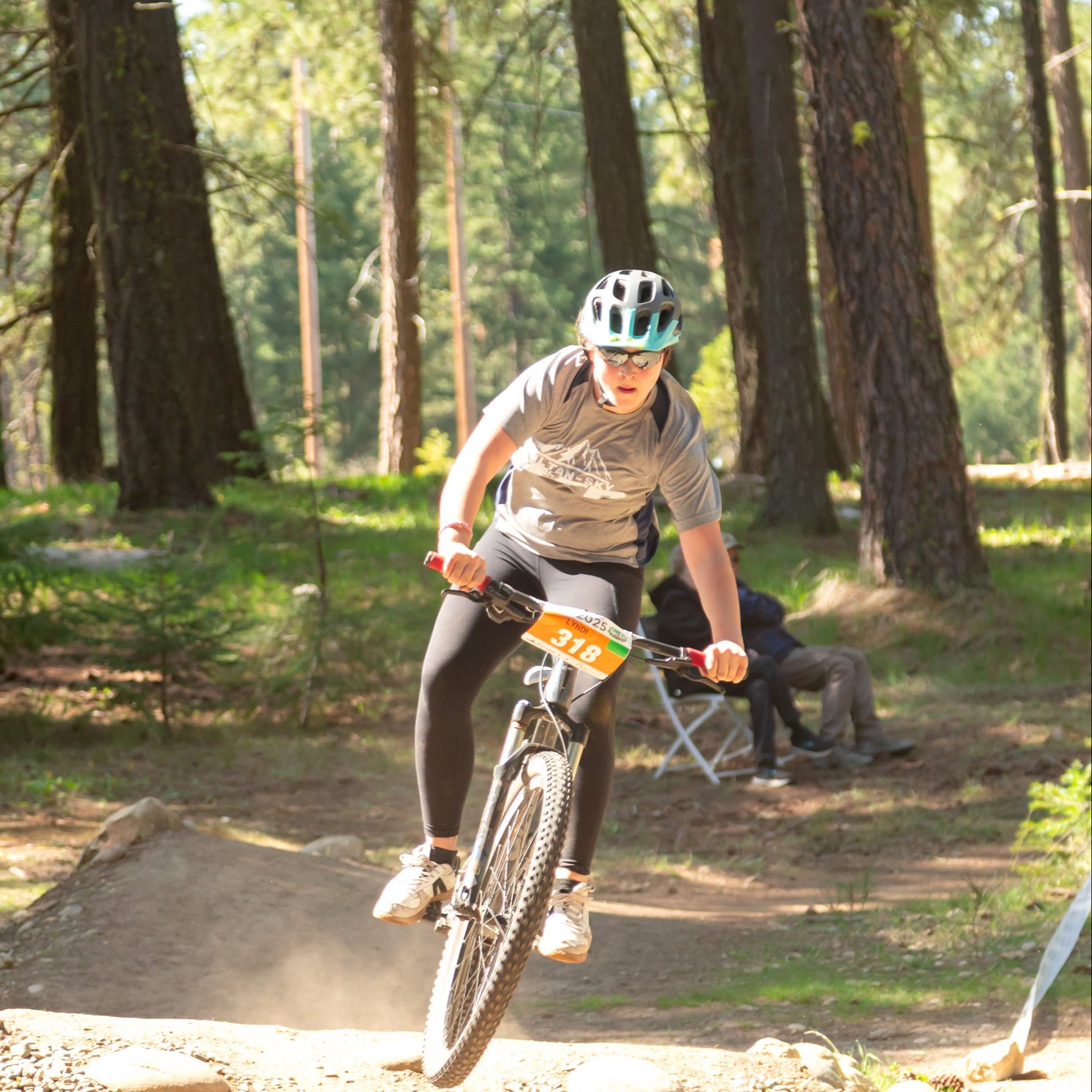 a mountain bike rider on a trail in the woods.