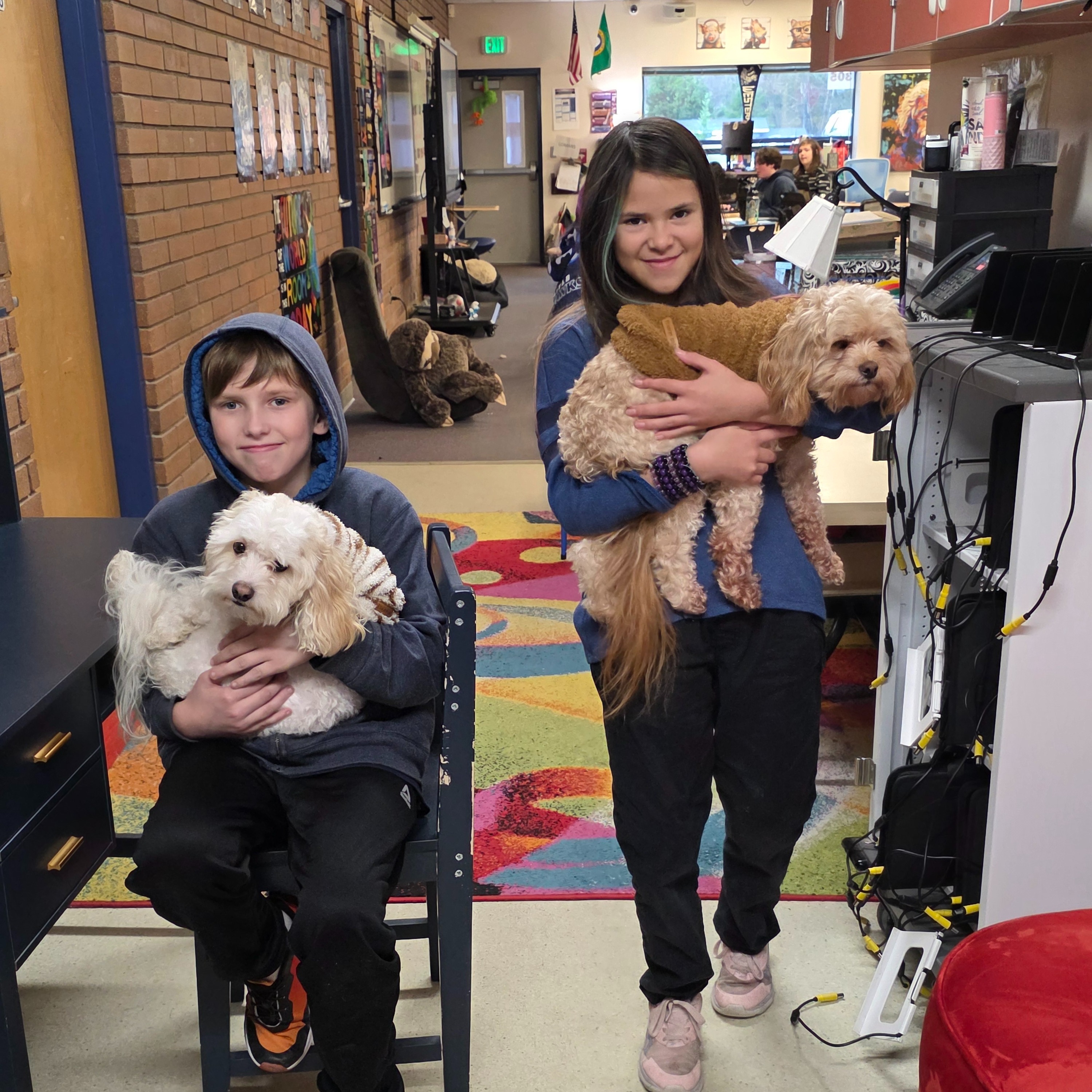 students holding small dogs