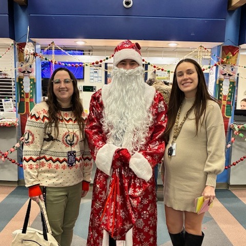 Principal Chapple dressed as Santa with Assistant Principal Paige Pereira and Karissa Kelley