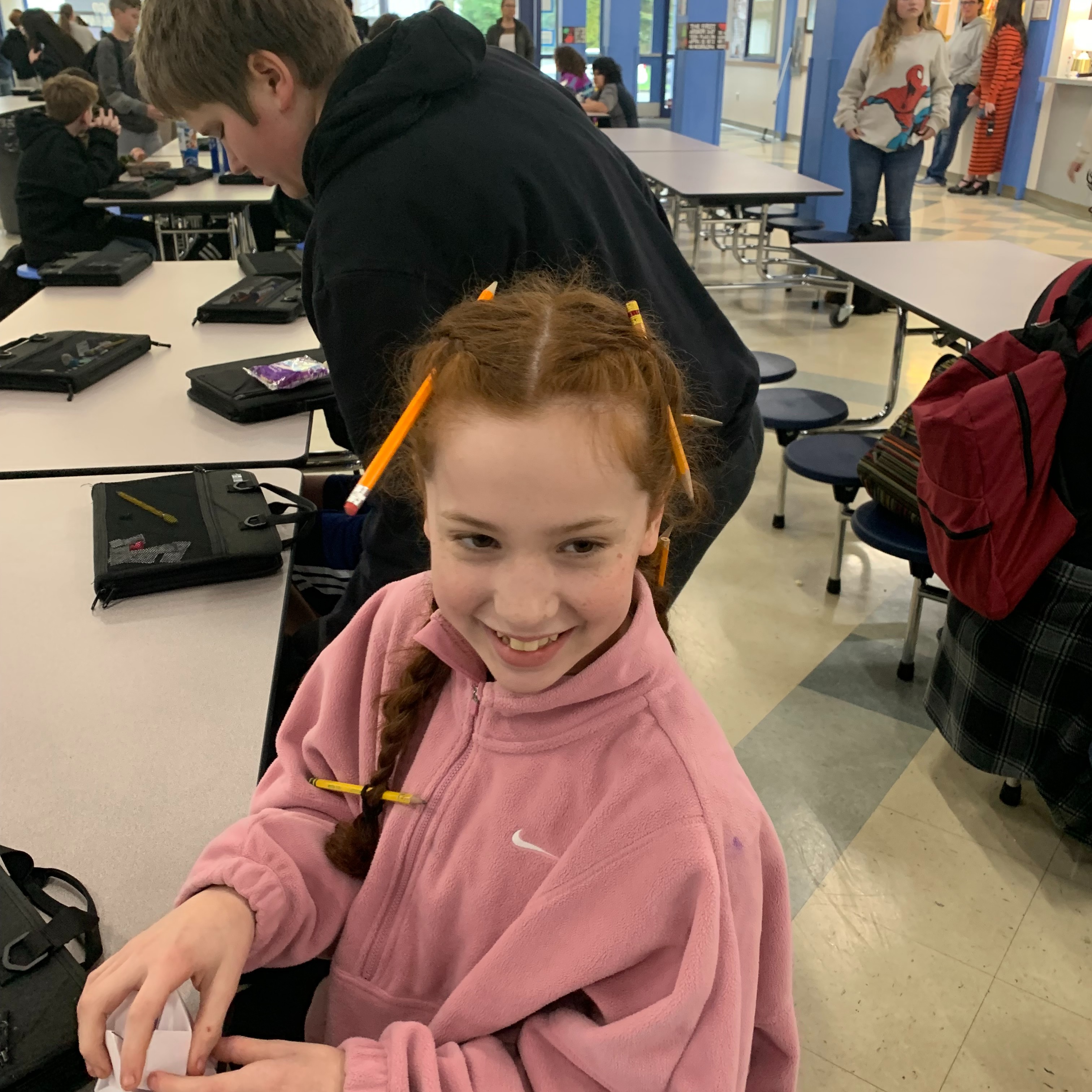 Girl with pencils in her braids.