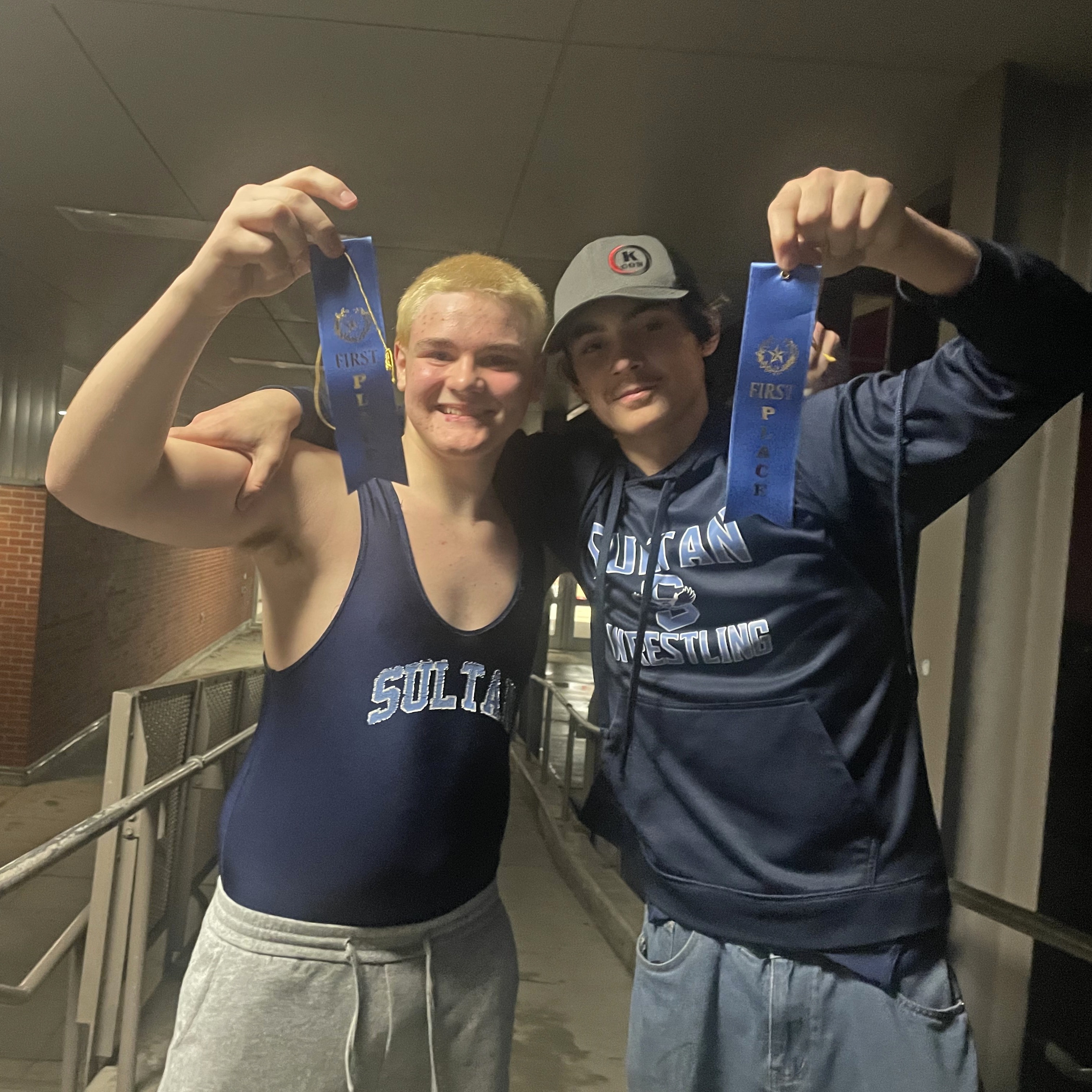 wrestlers holding first place ribbons