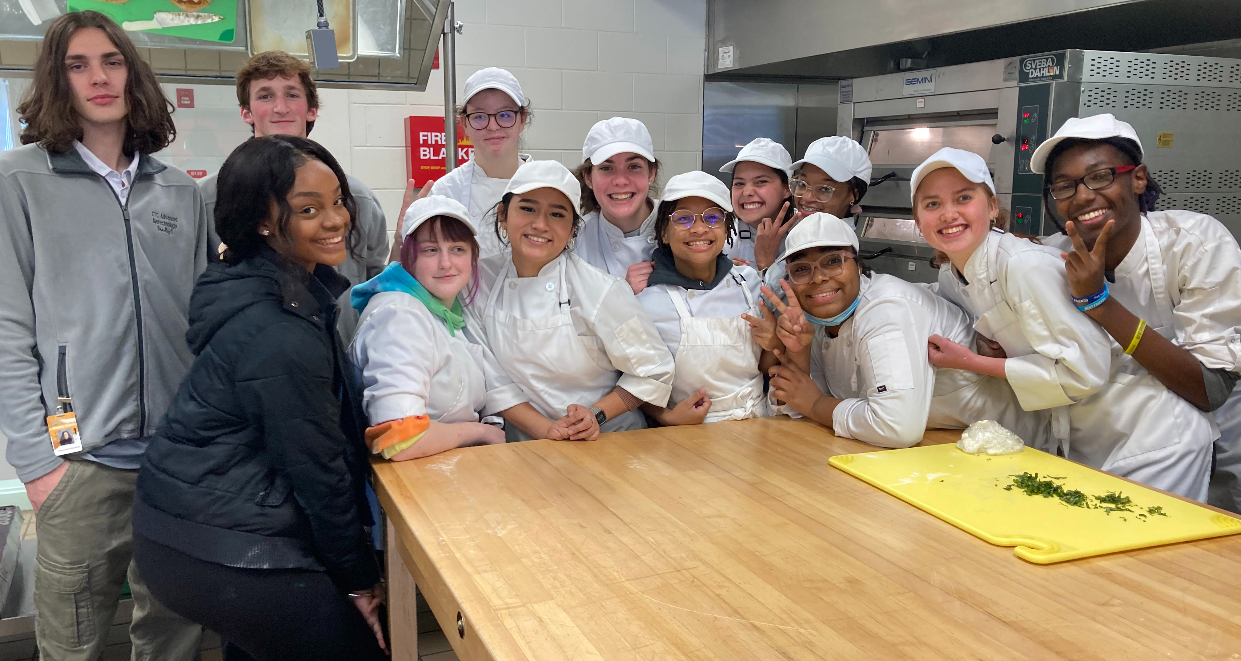A group of culinary students pose for a photo together