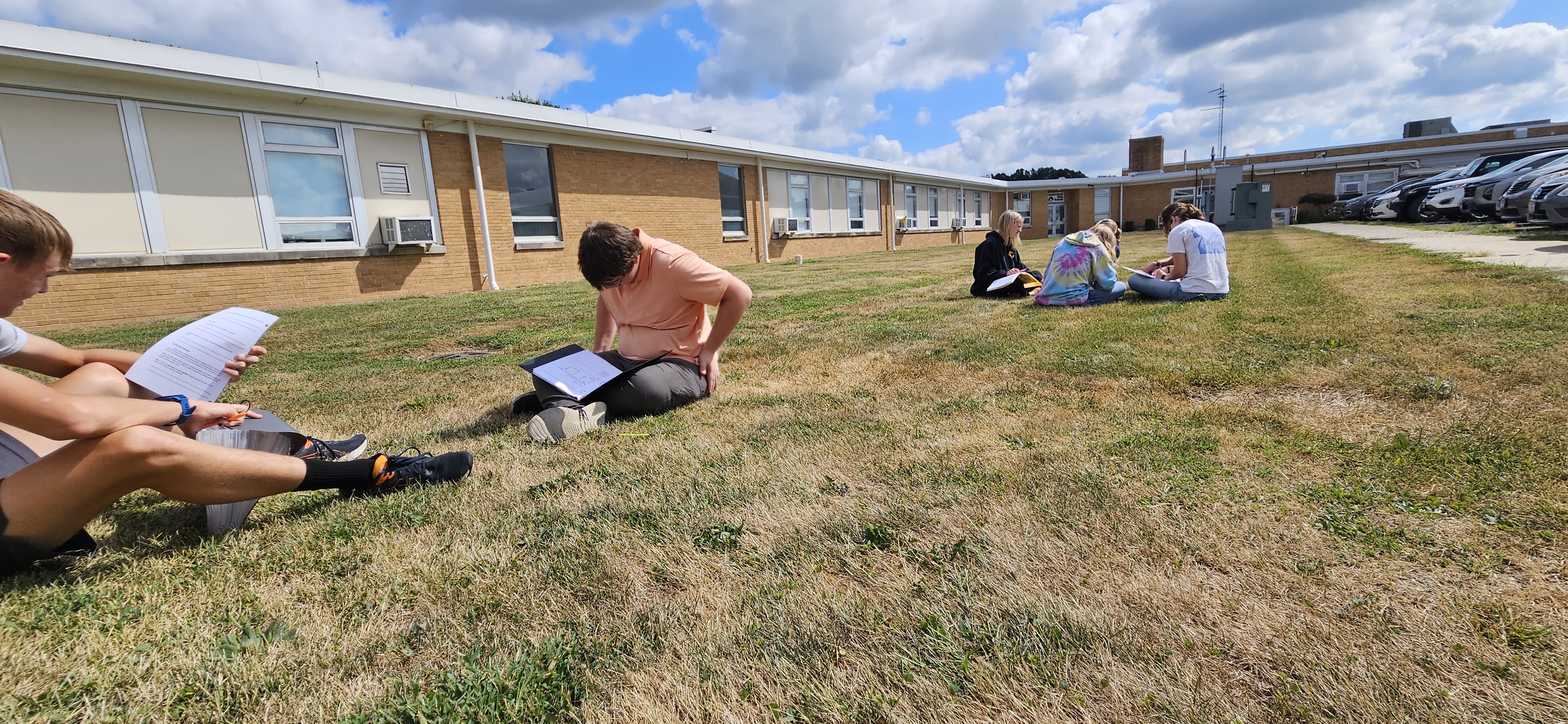 students reading outside
