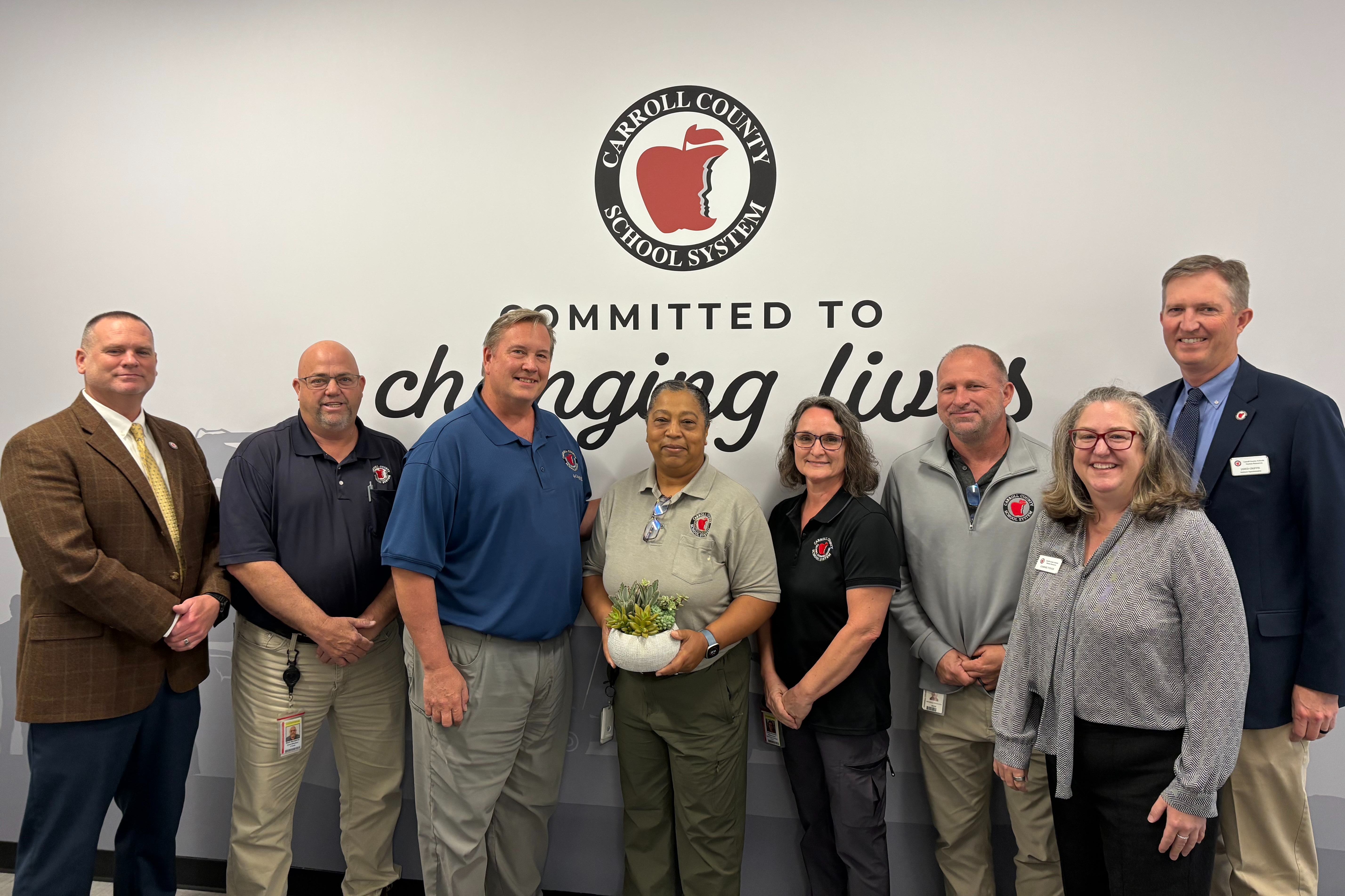 jada vaughn receives the 24 strong award for april 2026 surrounded by colleagues. 