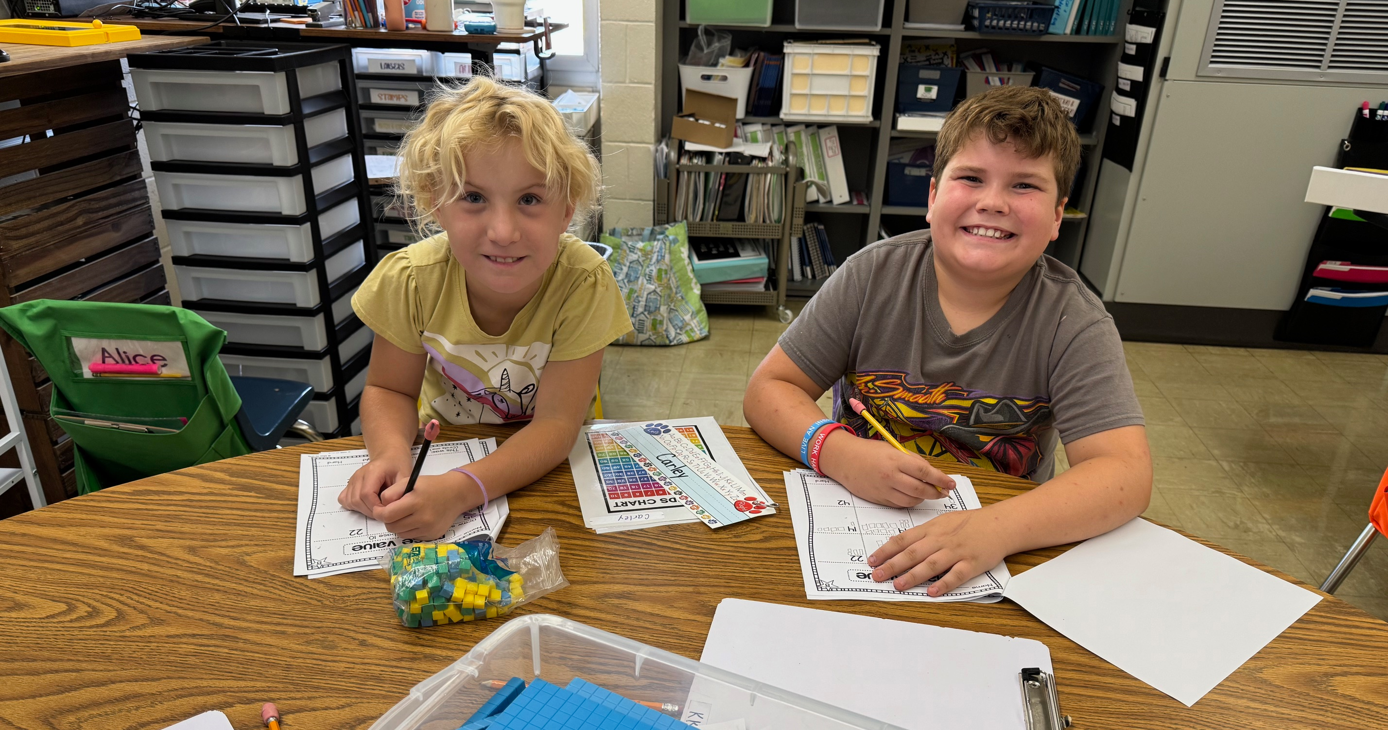 Two students are working on math activities.