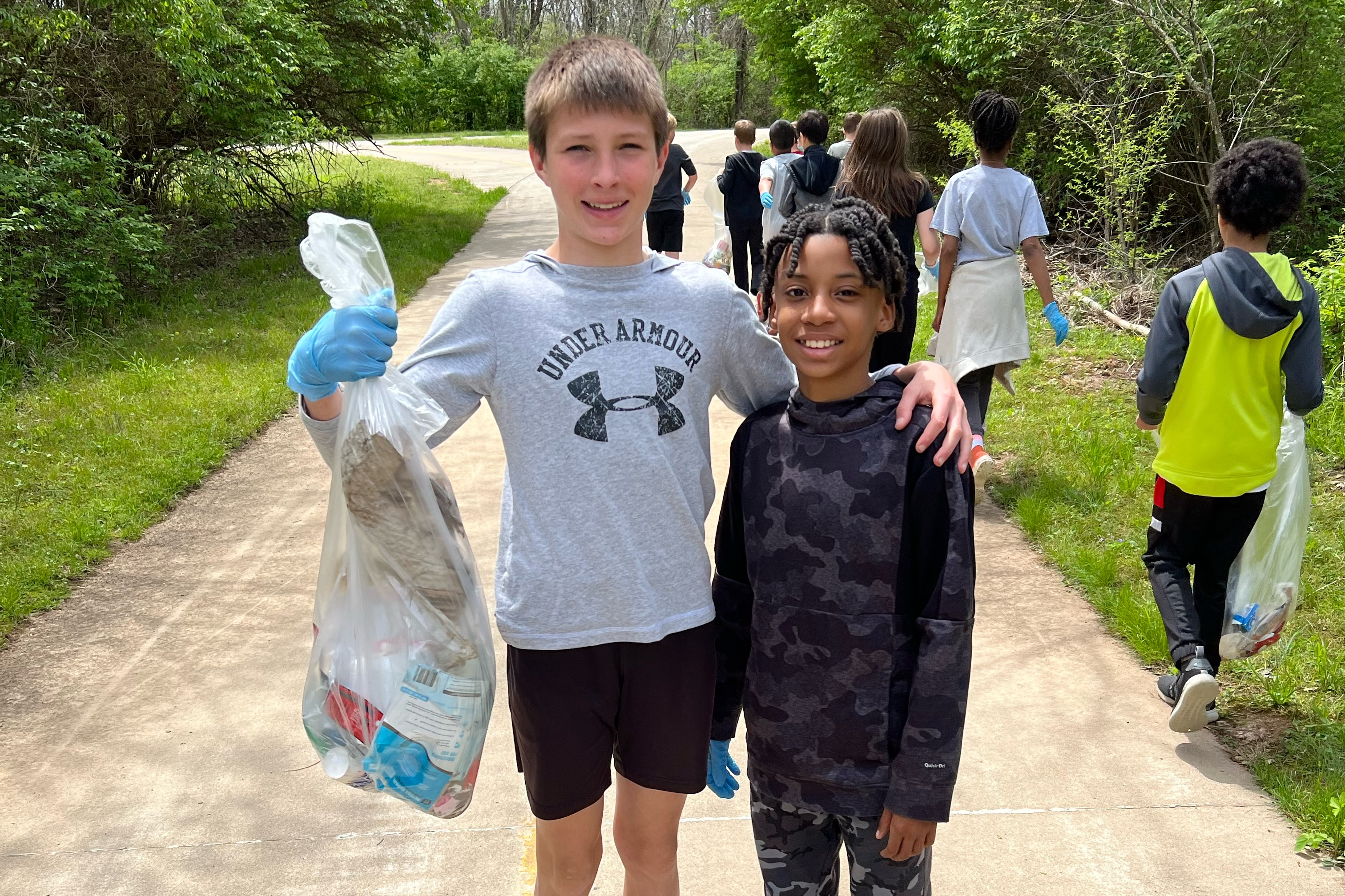 Students collecting litter around their school