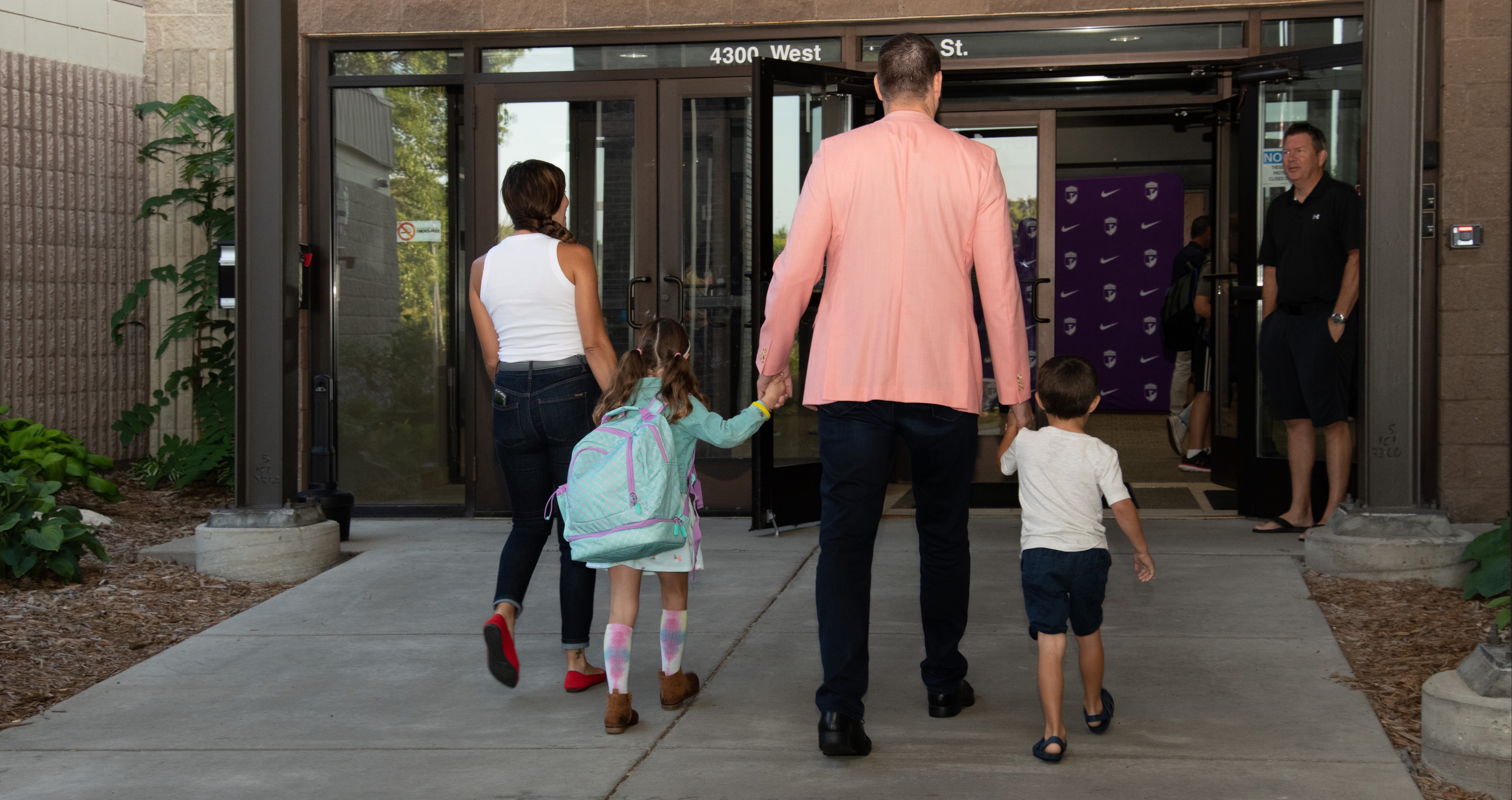 family walking into school