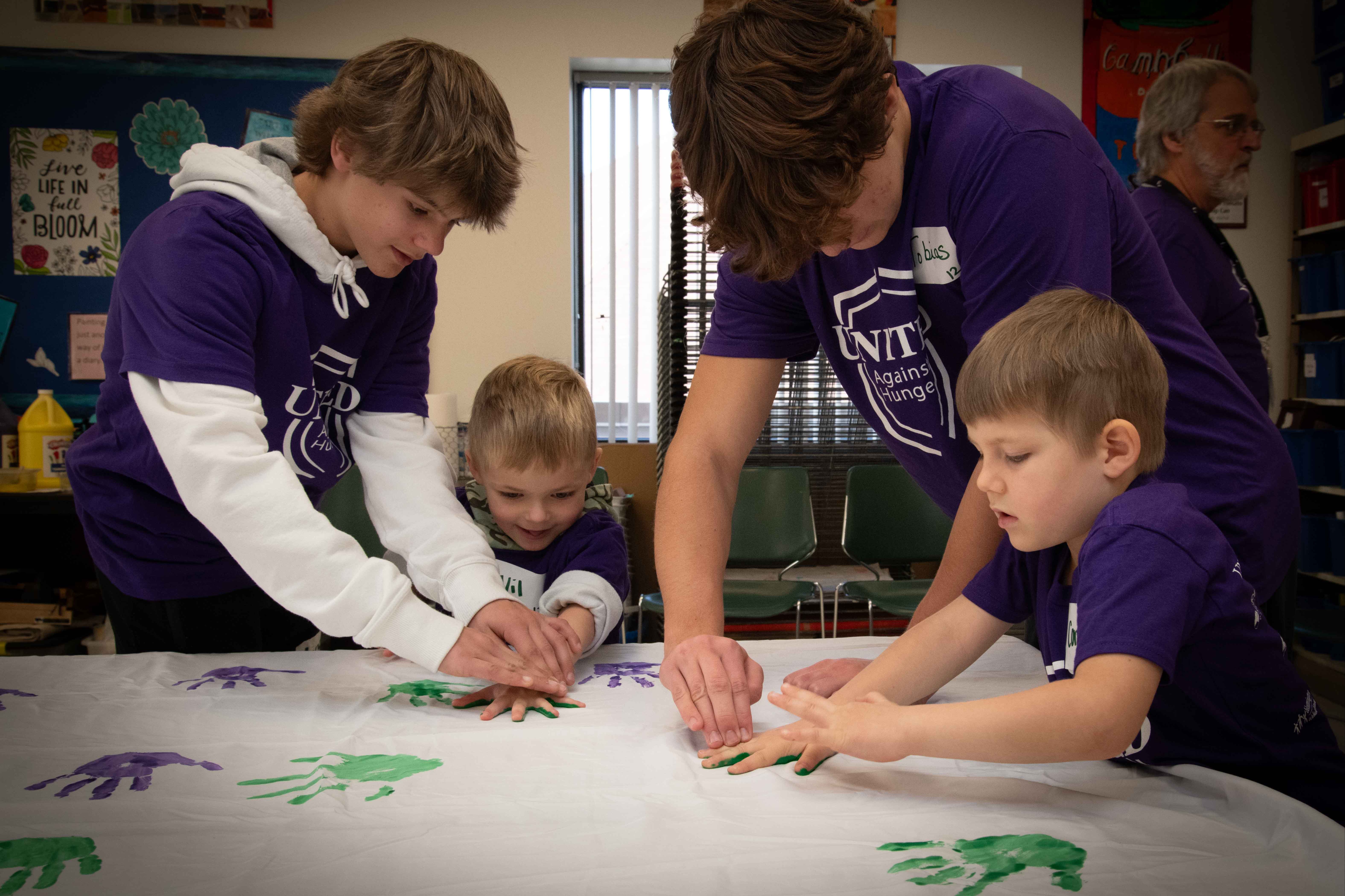 students making handprints with paint