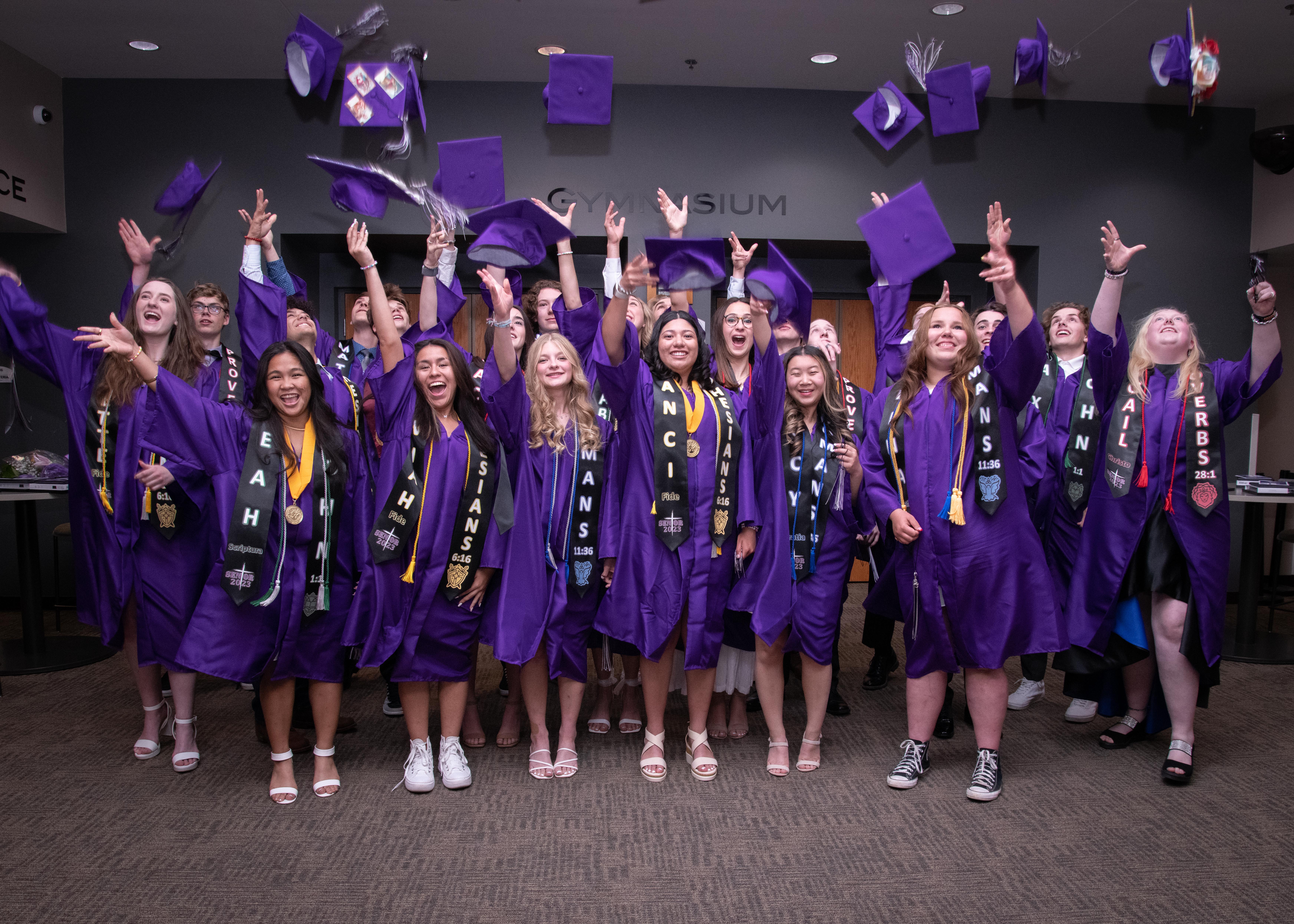 graduates throwing caps