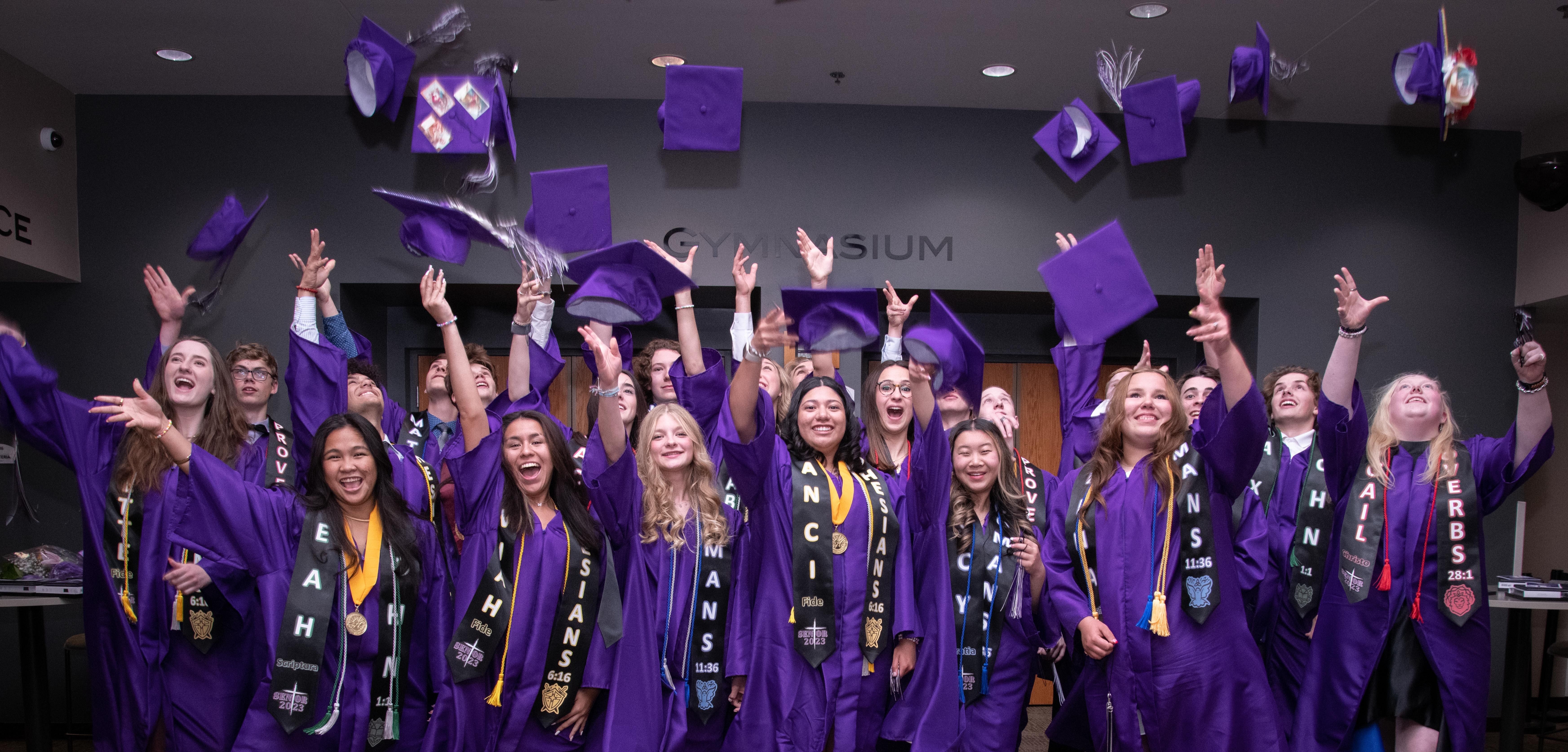 graduates throwing caps