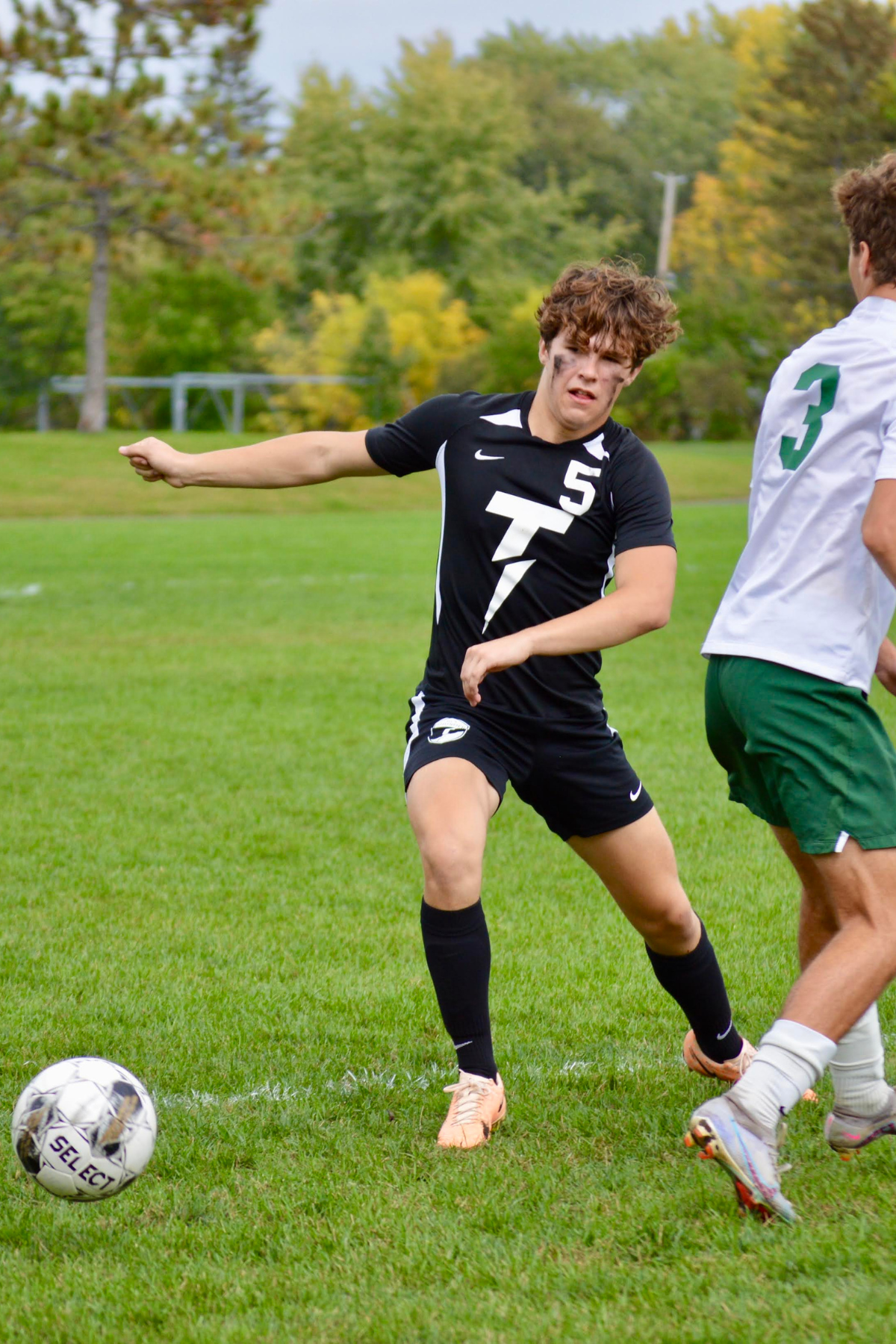 boy playing soccer