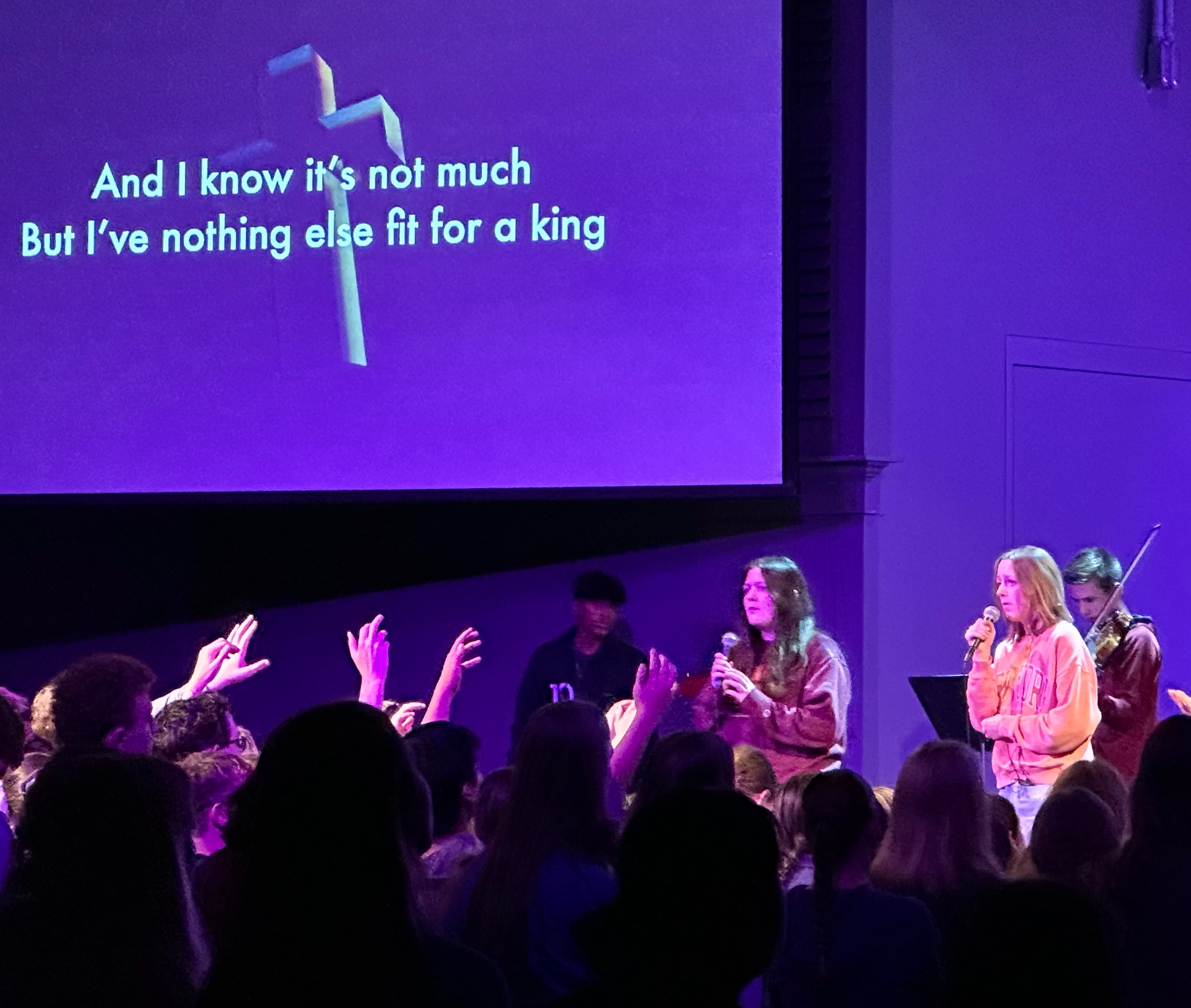 students singing in a chapel service