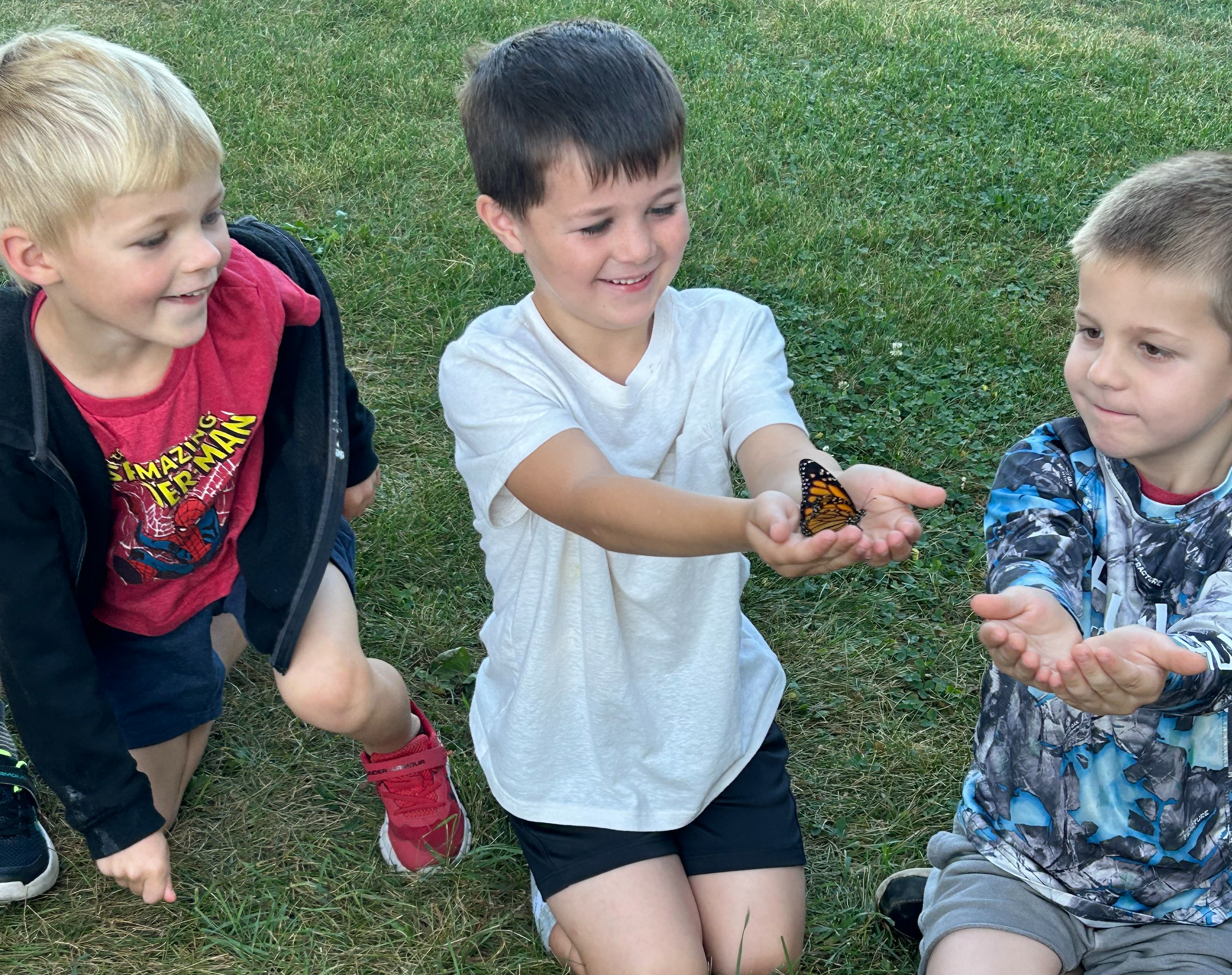 Students holding butterfliew