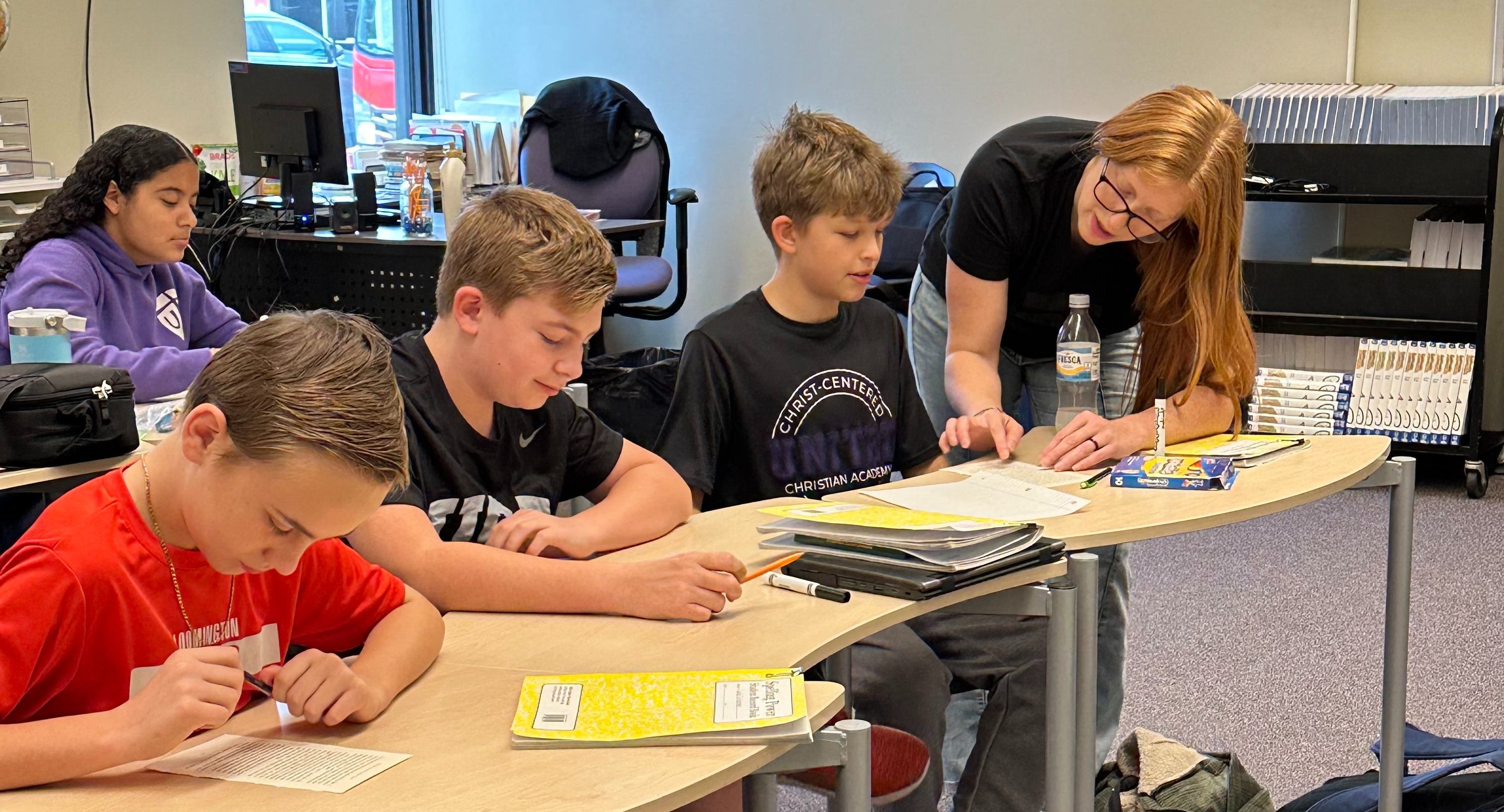 Middle School teacher helping a group of students