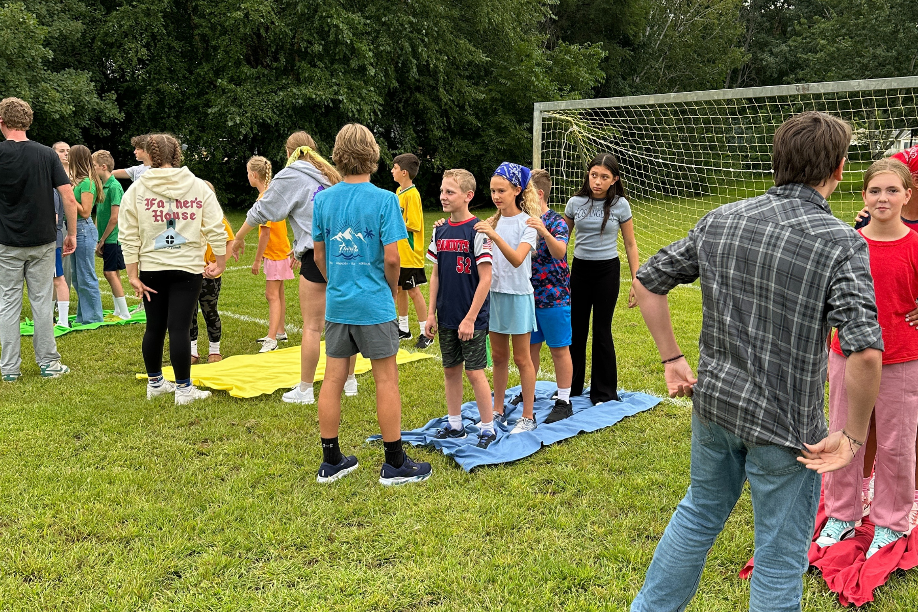 groups of students gathered in their houses getting ready for a house game