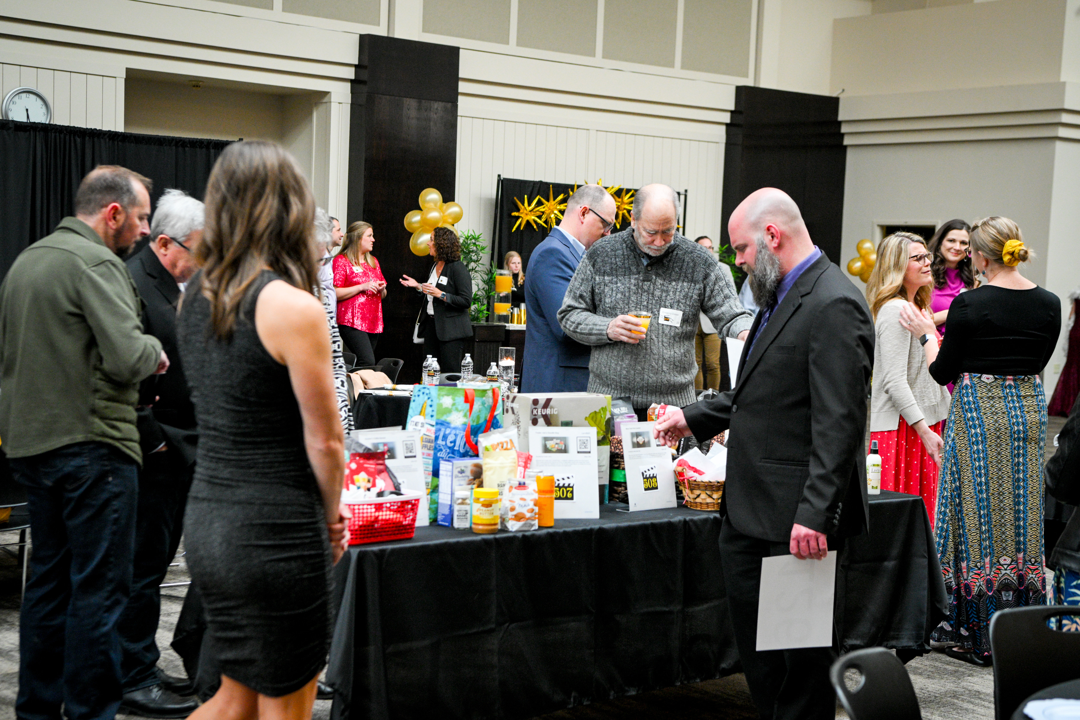 people looking at silent auction items