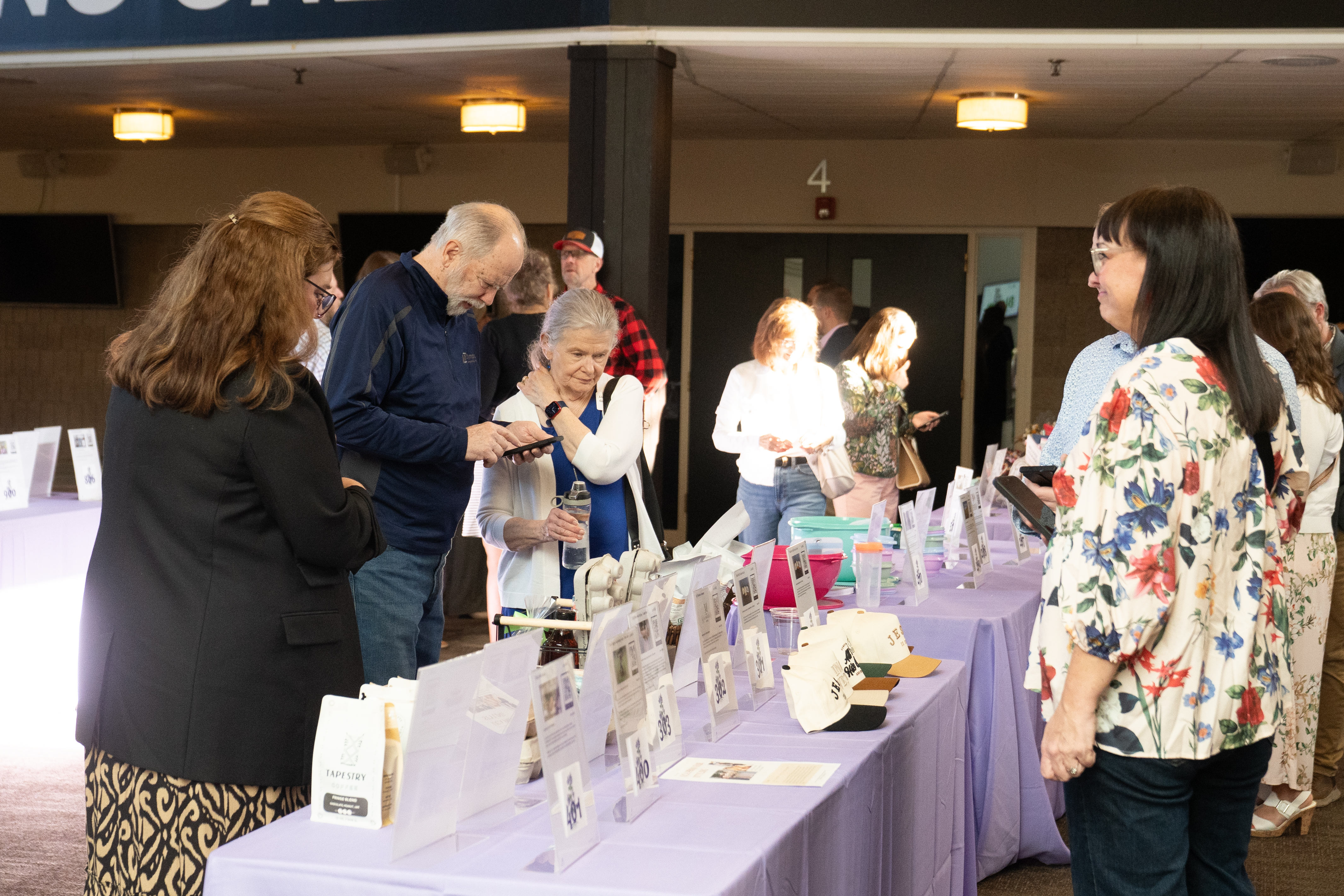 people looking at silent auction items