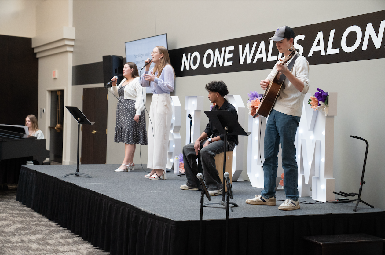 students worshiping on stage
