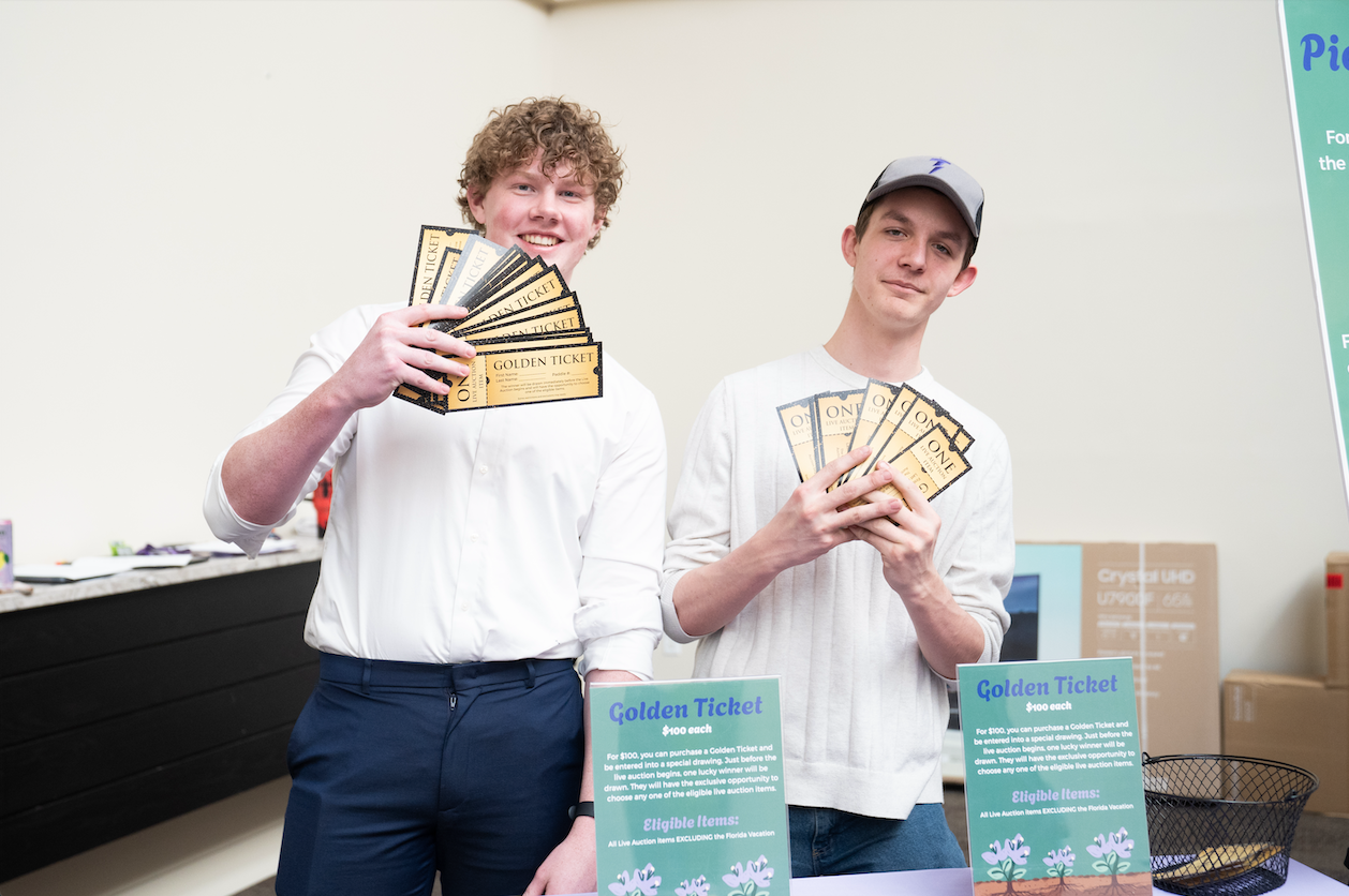 two students holding golden tickets