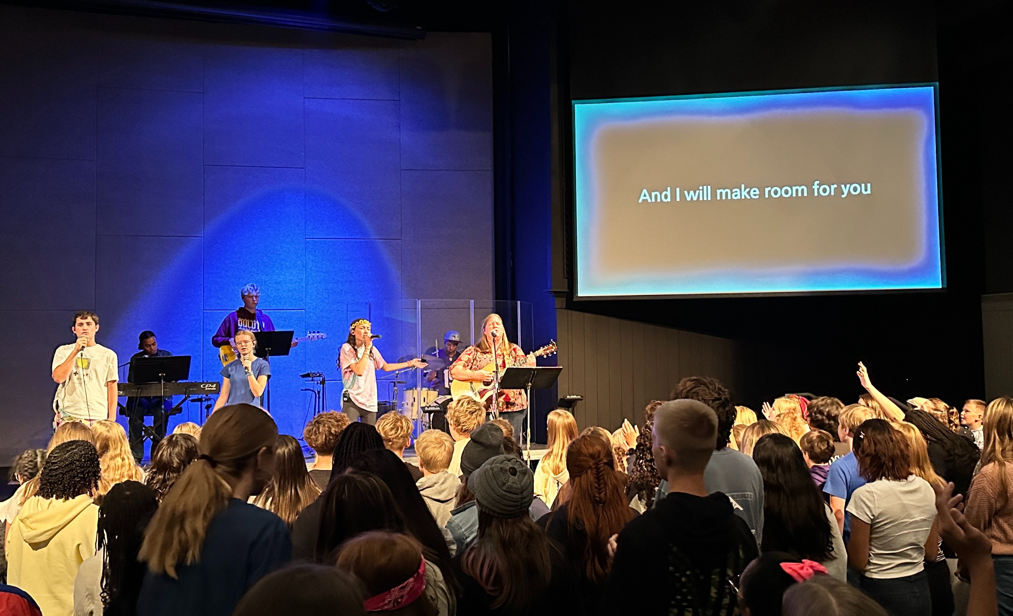 students singing in a chapel service