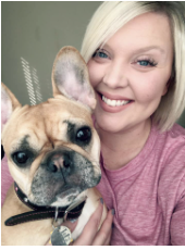 Ms. Polk holding her dog and smiling
