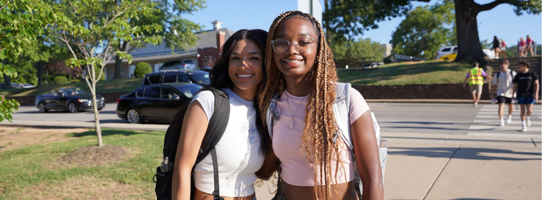 Two girls posing for a picture in front of FHS on the first day of school.
